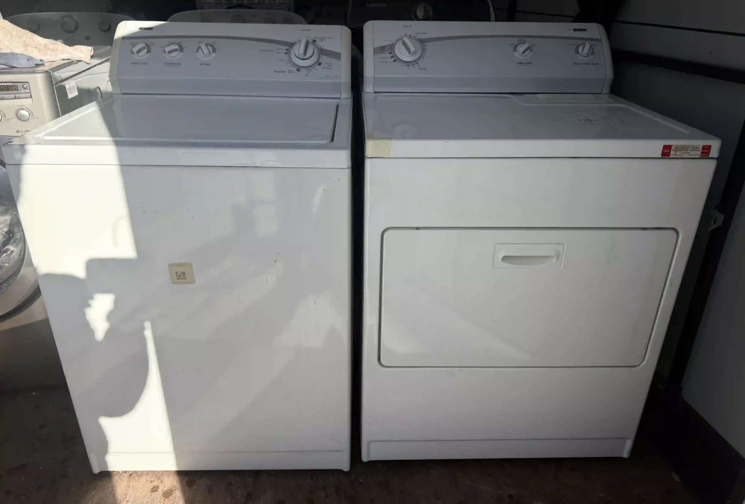 Kenmore heavy-duty top-load washer and matching electric dryer set in white, front view
