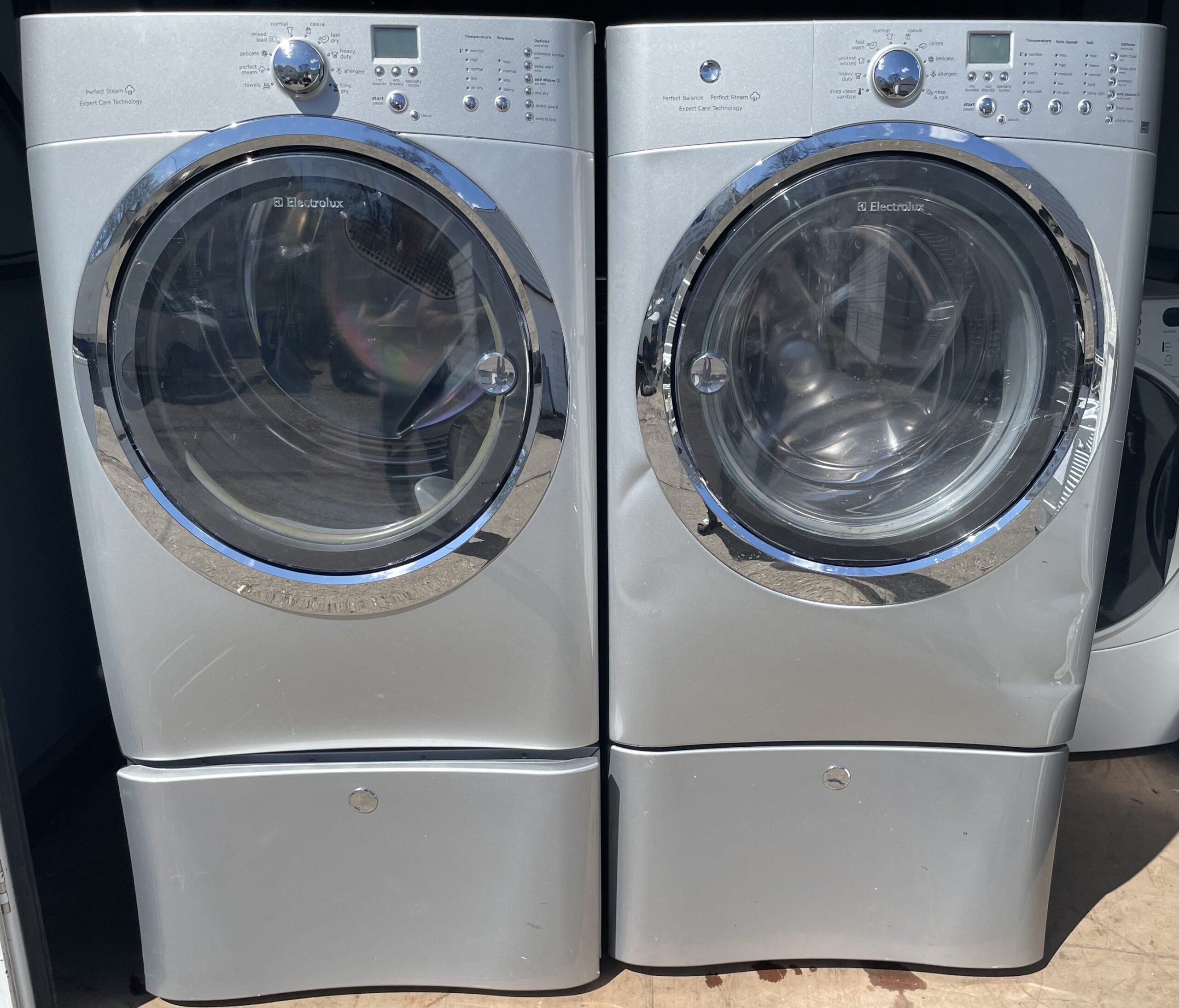 Electrolux silver washer and matching gas dryer set, front view