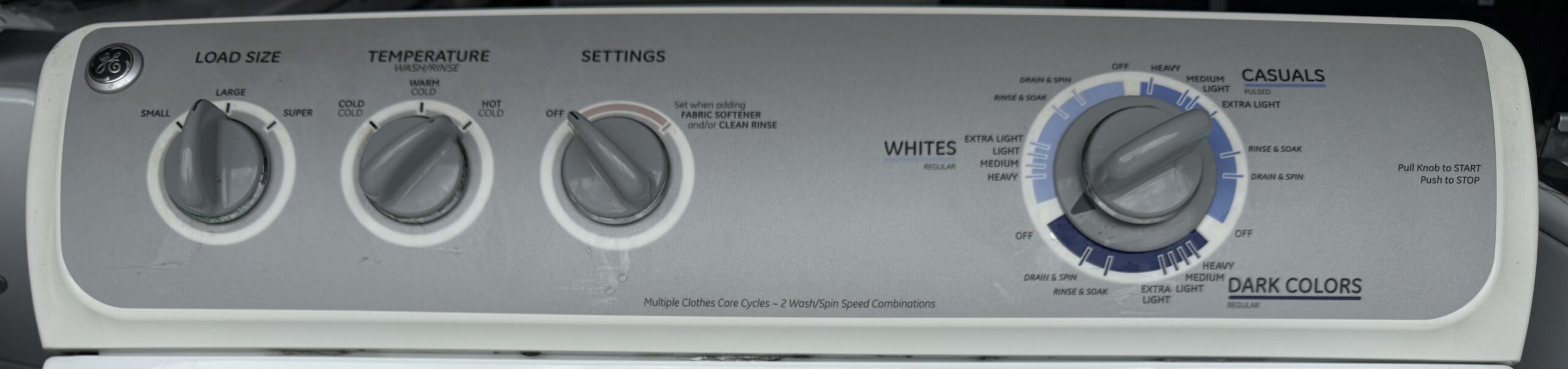 GE washer top-load lid open showing wash basket and agitator