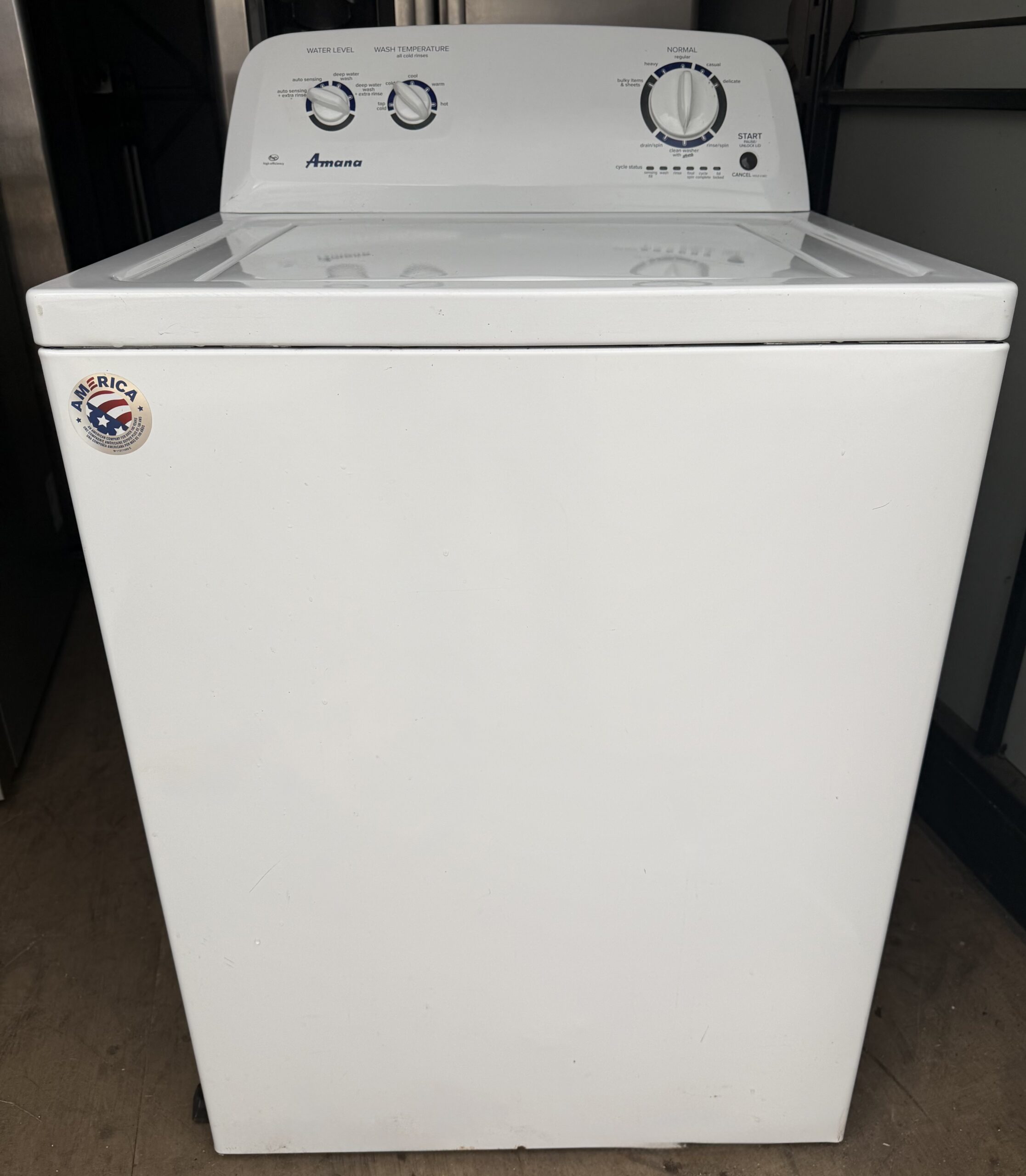 Amana washer top-load style, front view with lid closed