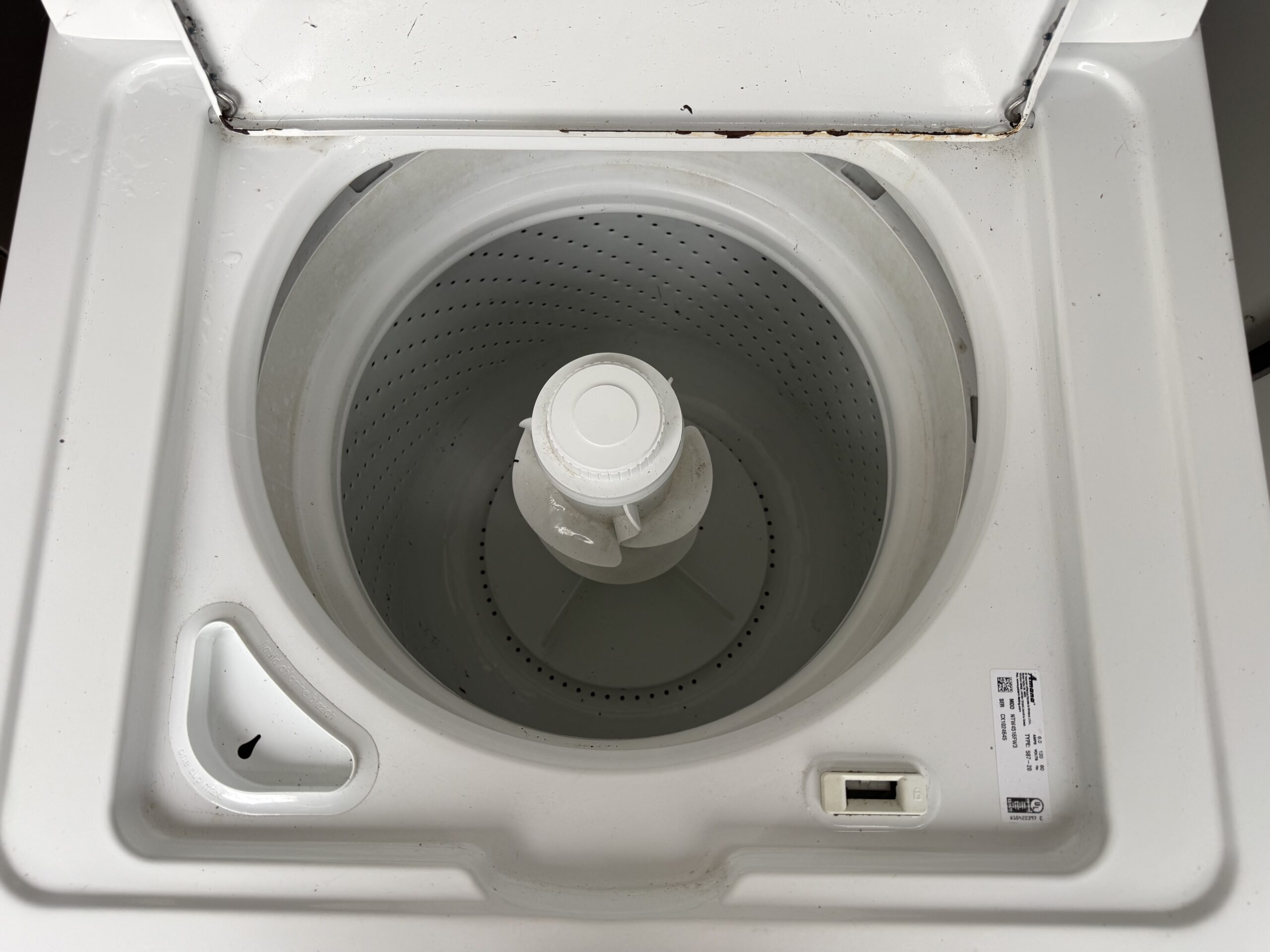Amana washer top-load lid open showing wash basket and agitator
