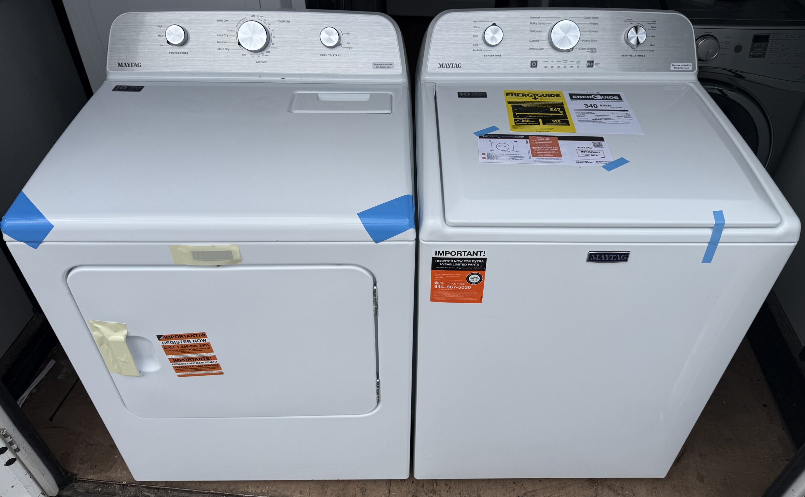 Maytag top load washer and electric dryer set in white, front view