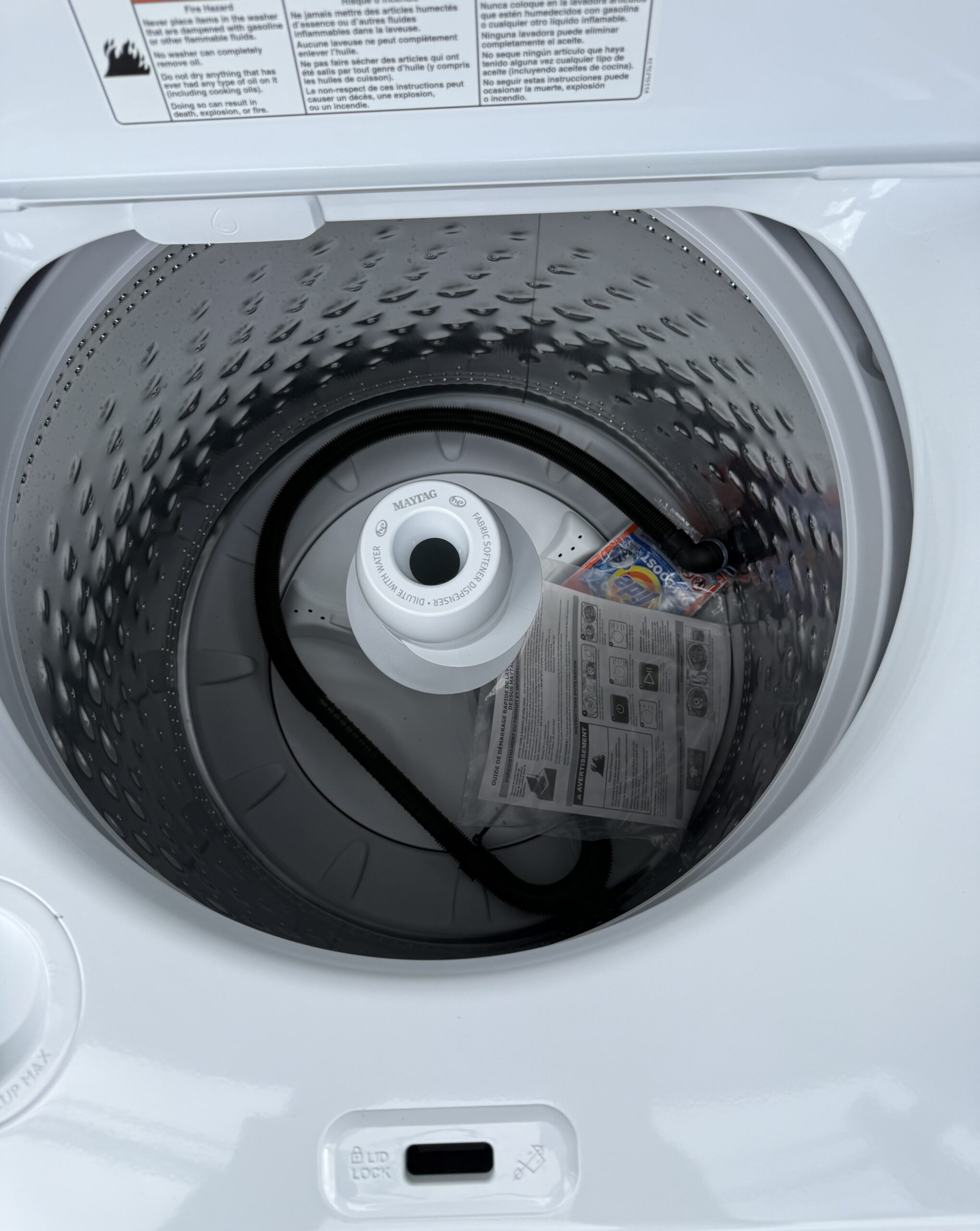 Maytag top load washer interior tub and agitator viewed from above