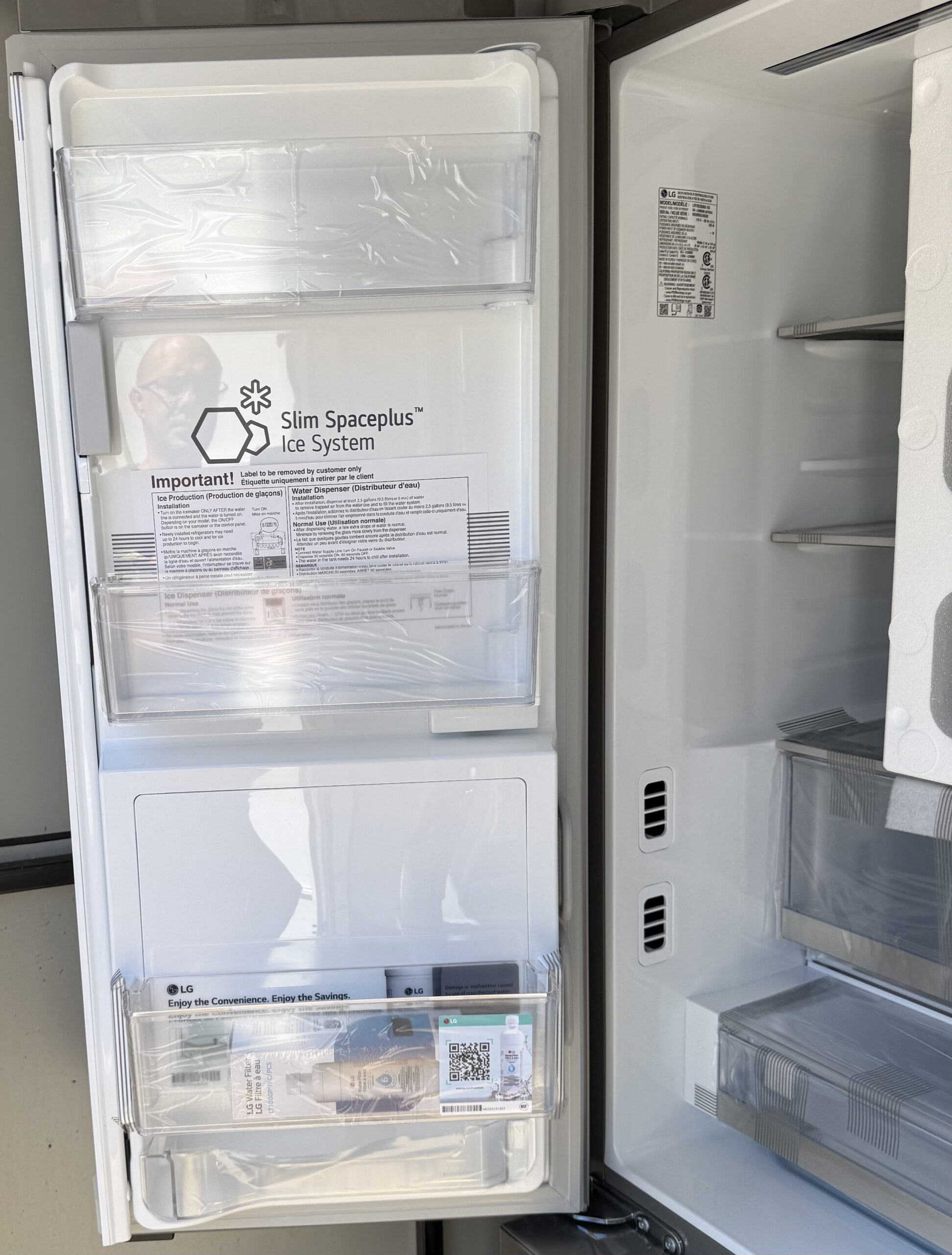 LG French door refrigerator interior with True Spaceplus shelving and protective wrap