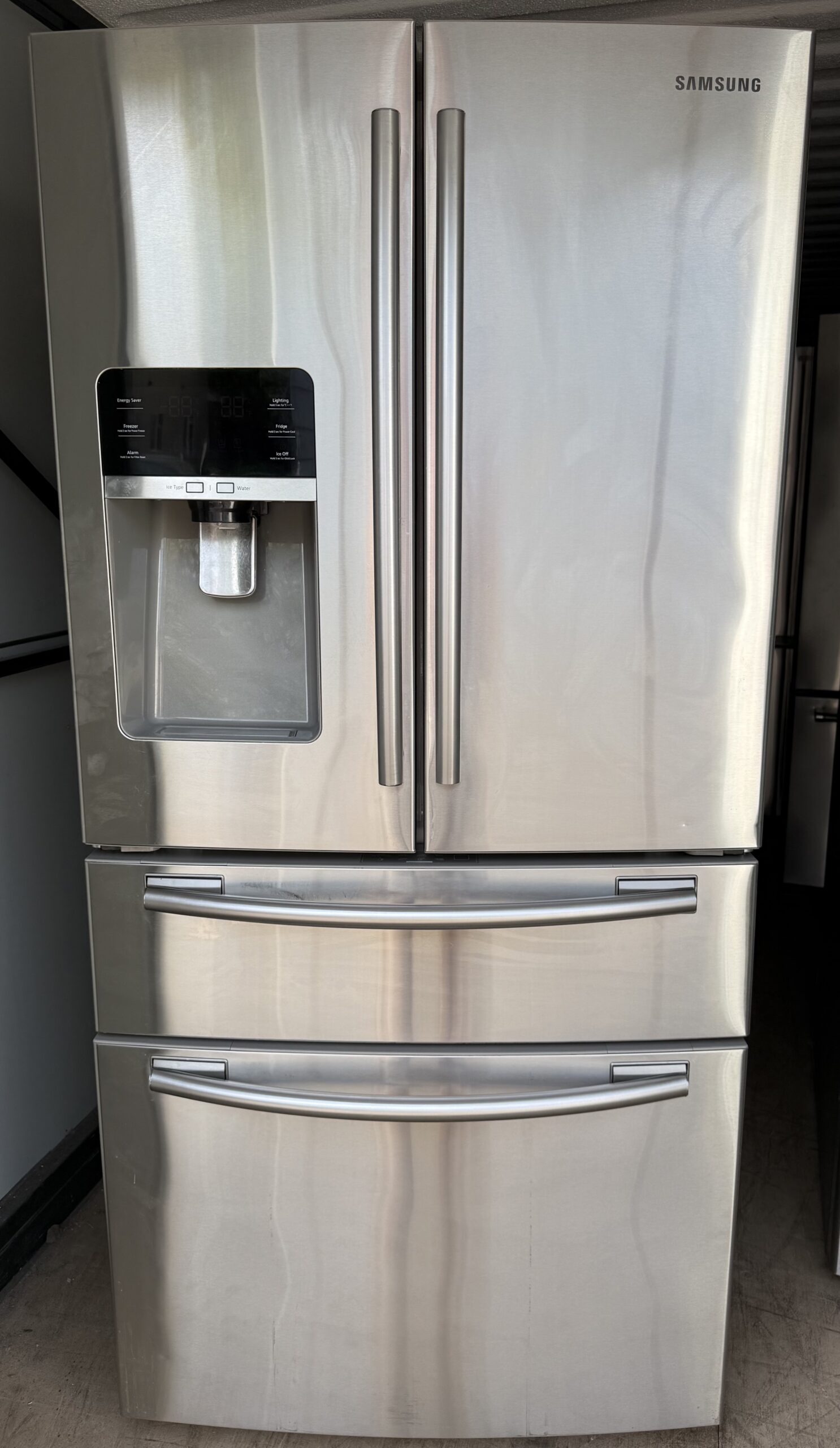 Samsung 25.5 cu ft 4-Door French Door Refrigerator in stainless steel with external water and ice dispenser and dual bottom drawers, front view