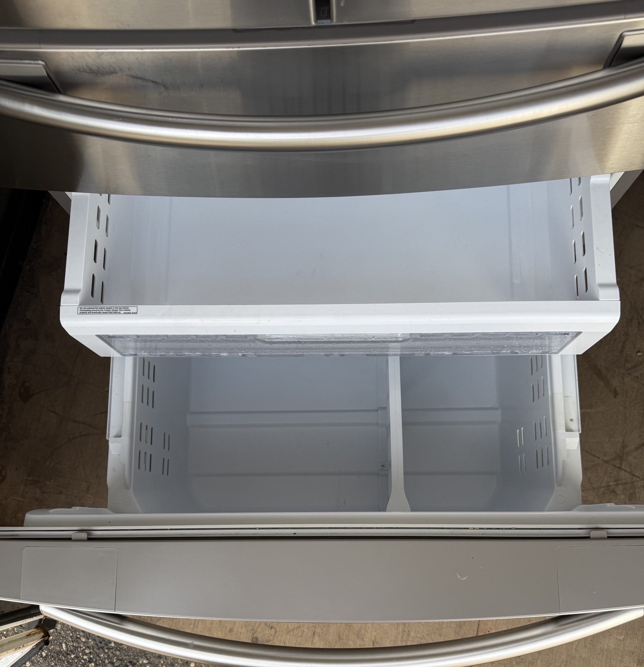 Samsung refrigerator dual freezer drawers pulled open showing two-tier organization