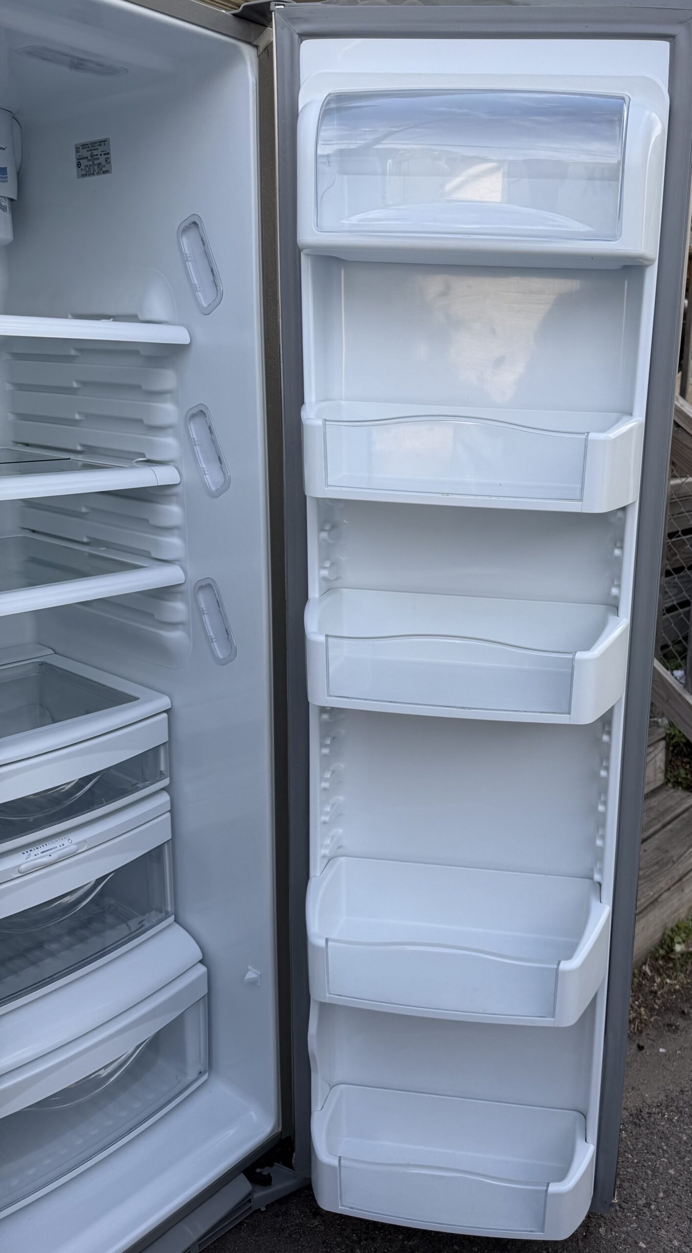 GE Profile refrigerator — fresh-food door bins and adjustable shelves.