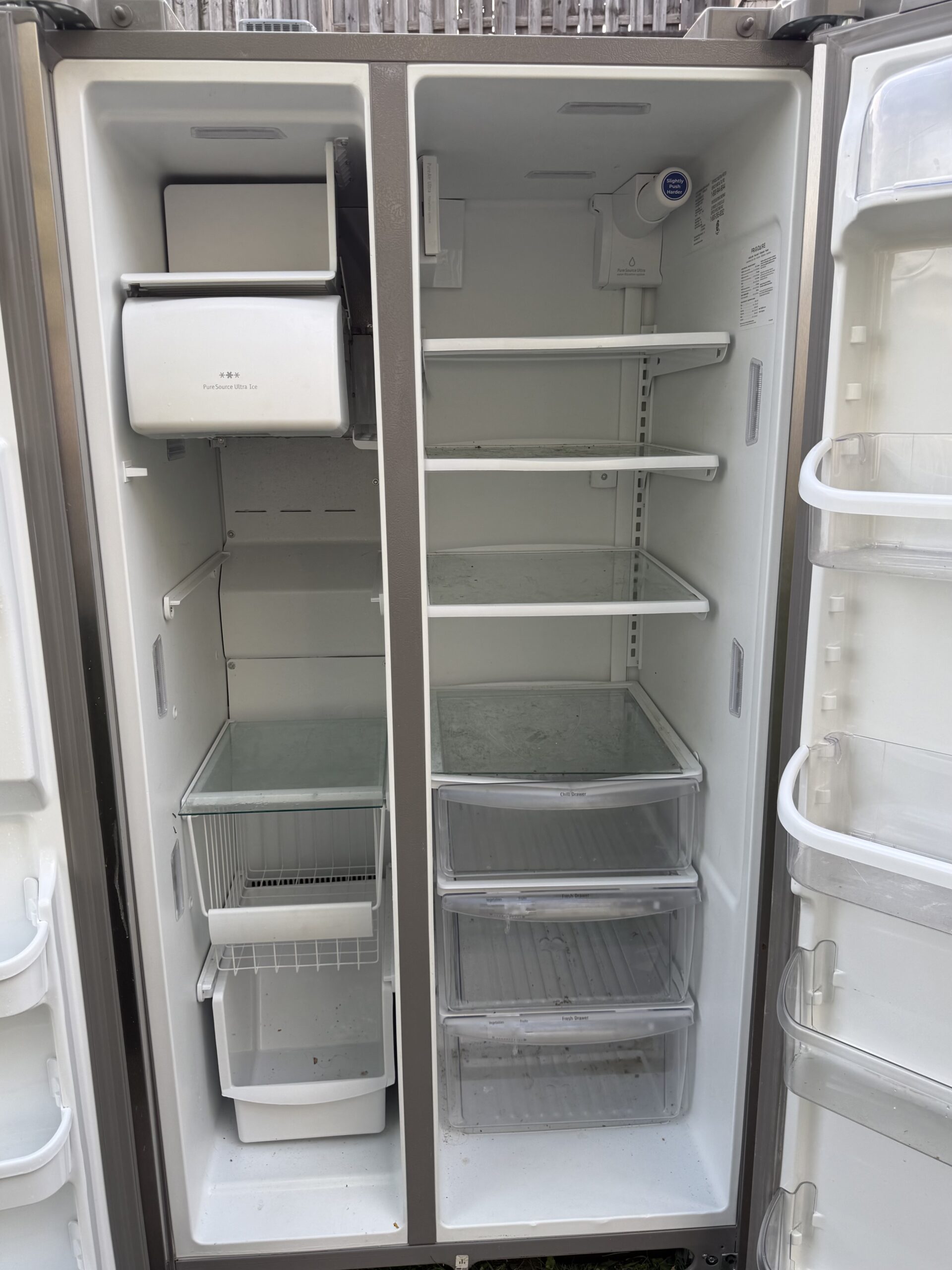 Frigidaire Gallery side-by-side refrigerator interior shelving and freezer side