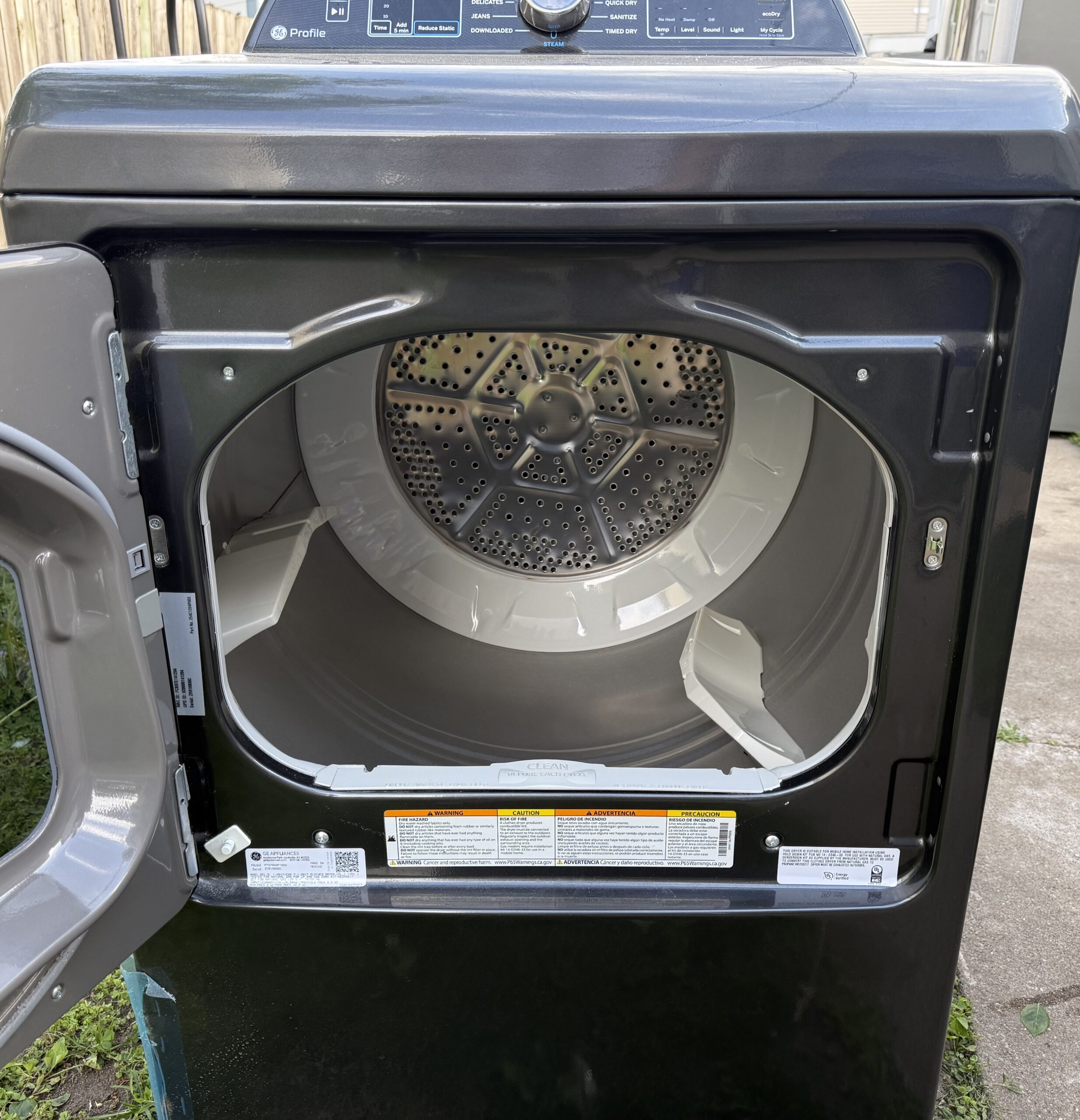 GE Profile gas dryer with door open showing the drum interior
