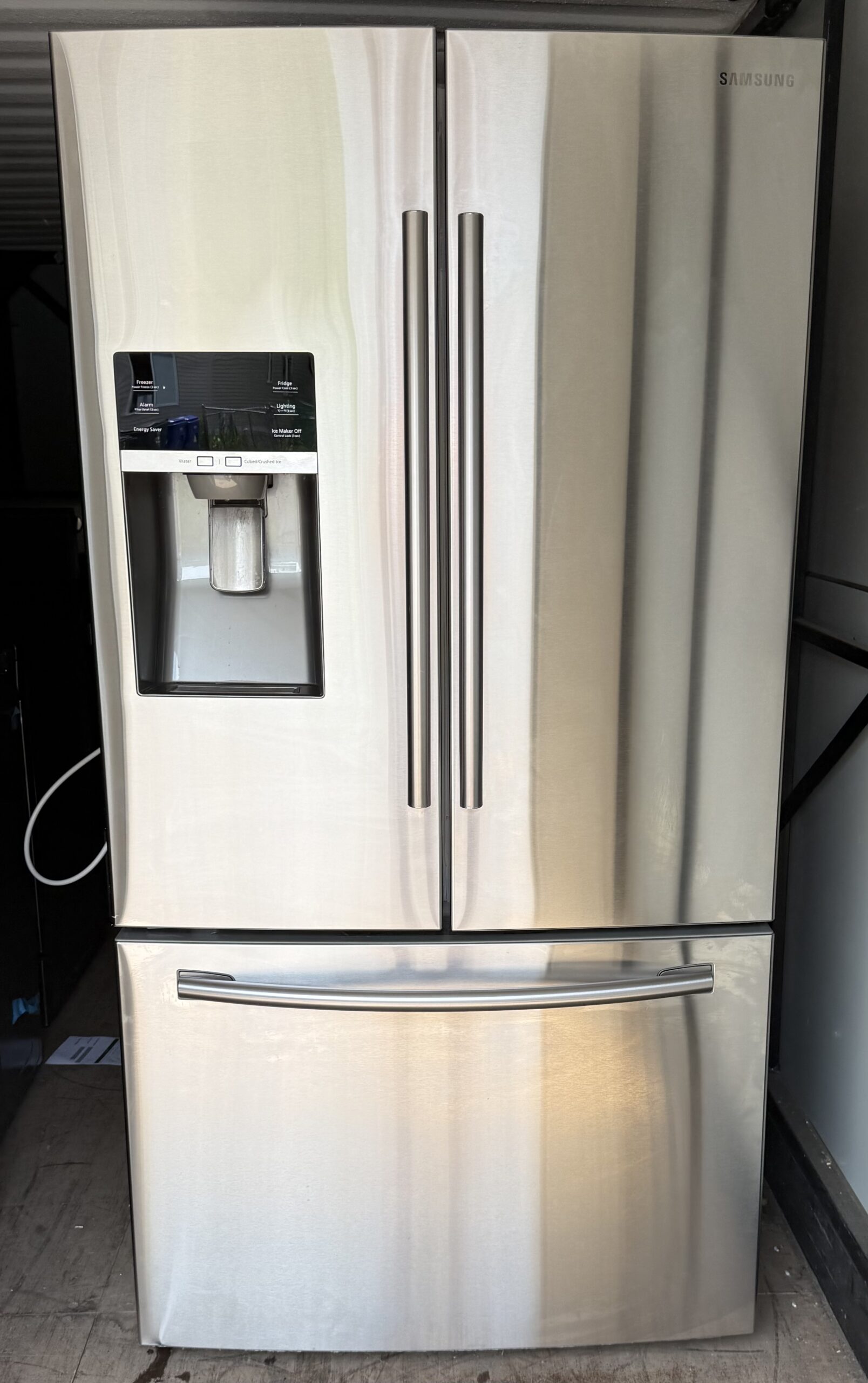 Samsung 28 cu ft 3-door French door refrigerator in stainless steel with external ice and water dispenser, front view