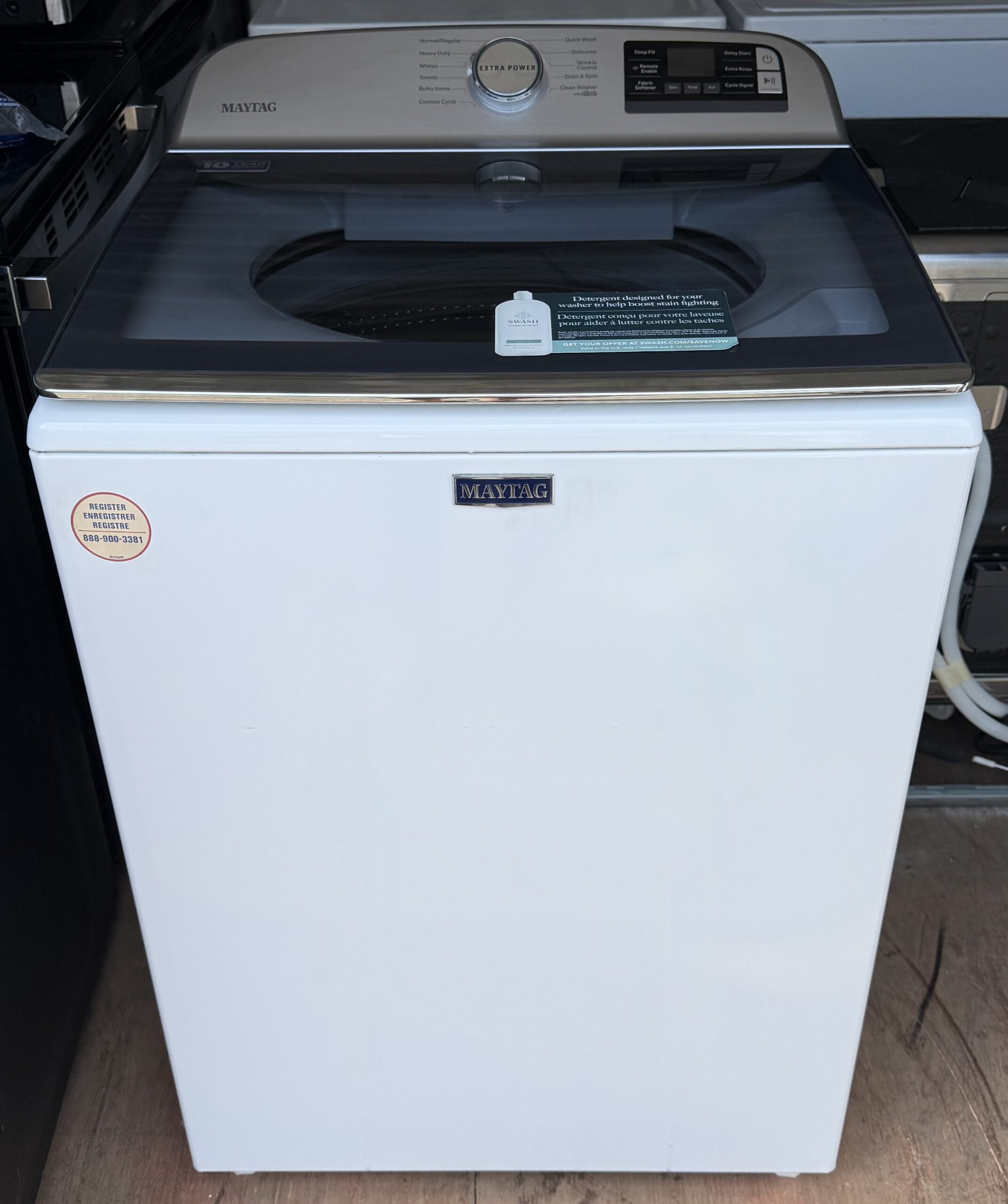 Maytag white top-load washer front view with stainless control panel
