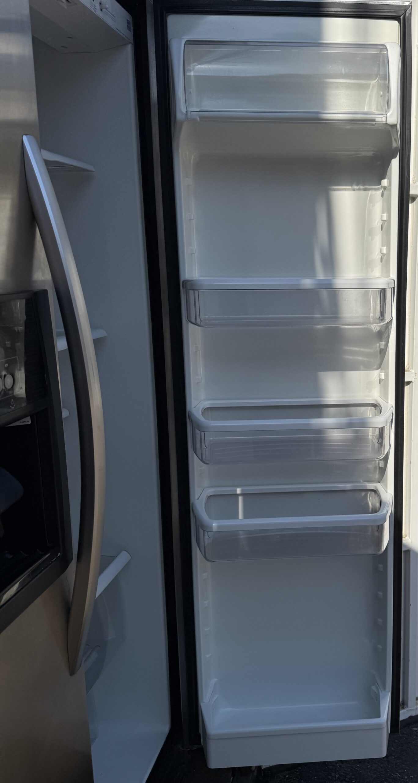 Whirlpool side-by-side refrigerator door bins and dispenser interior