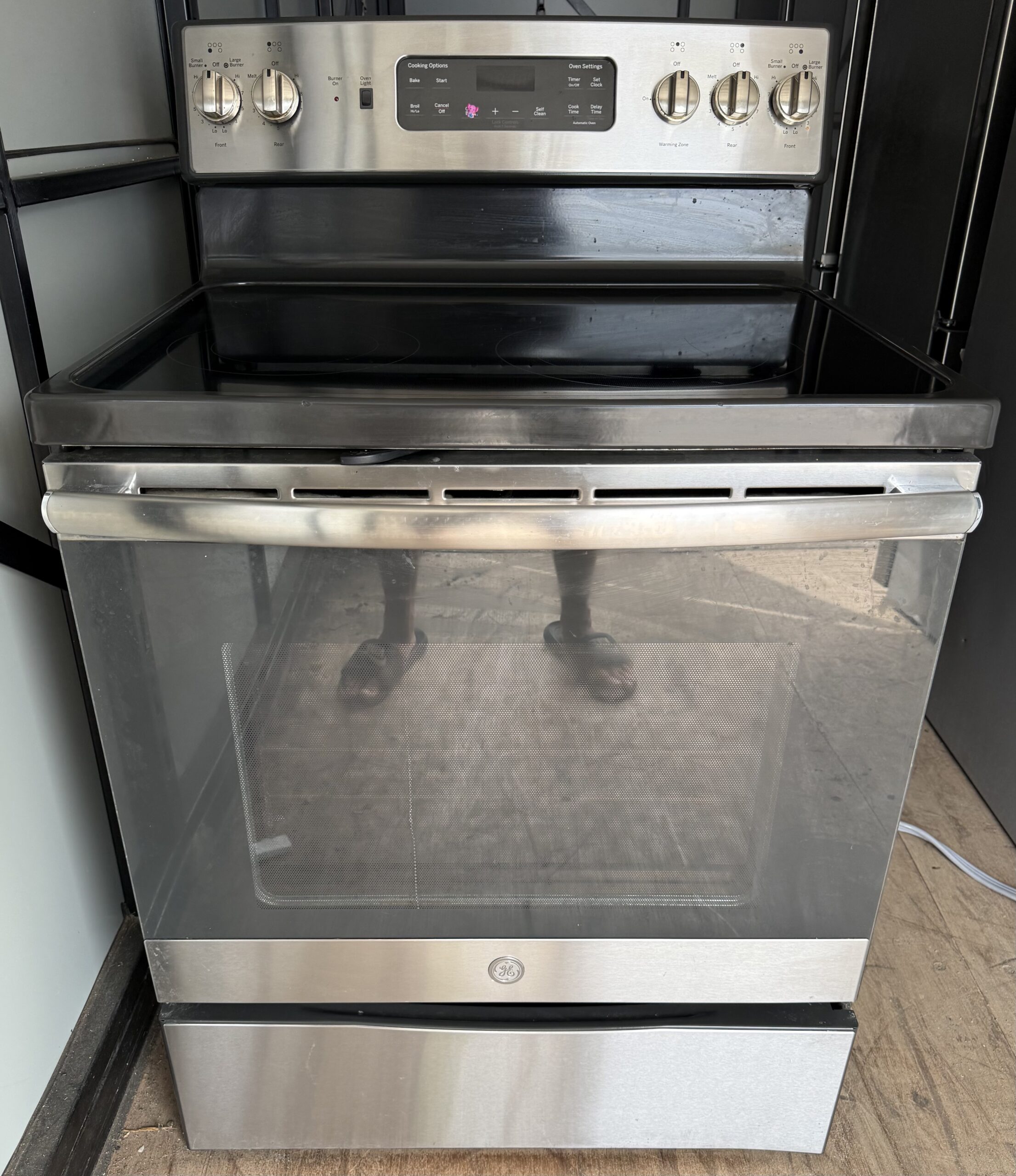 GE 30 inch electric range stainless steel smooth glass top — front view