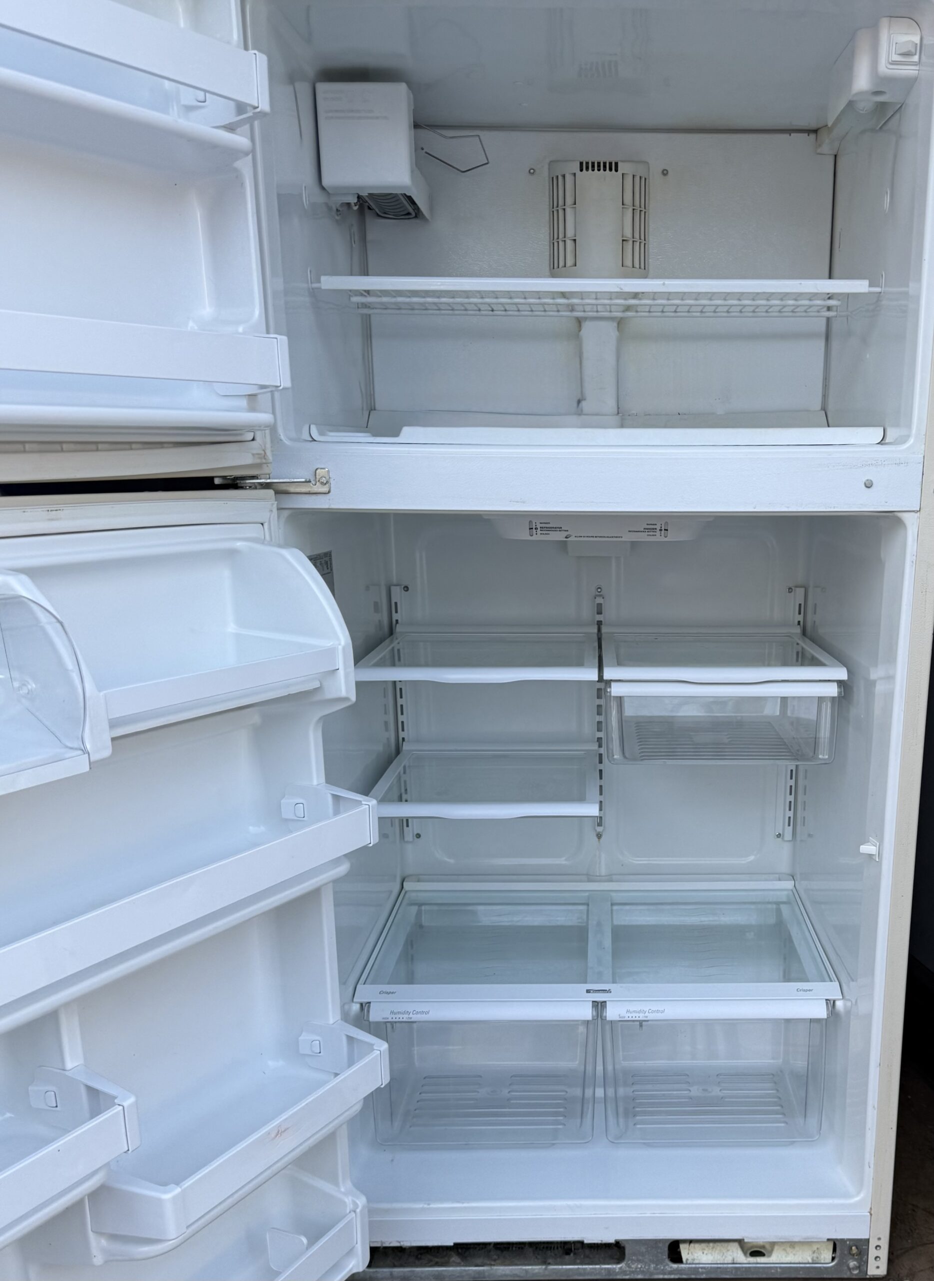 Kenmore refrigerator interior with shelves and crispers