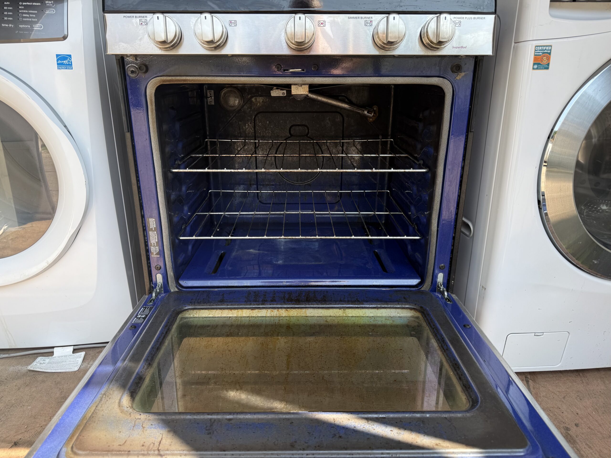 LG gas range oven interior with two chrome racks, door open