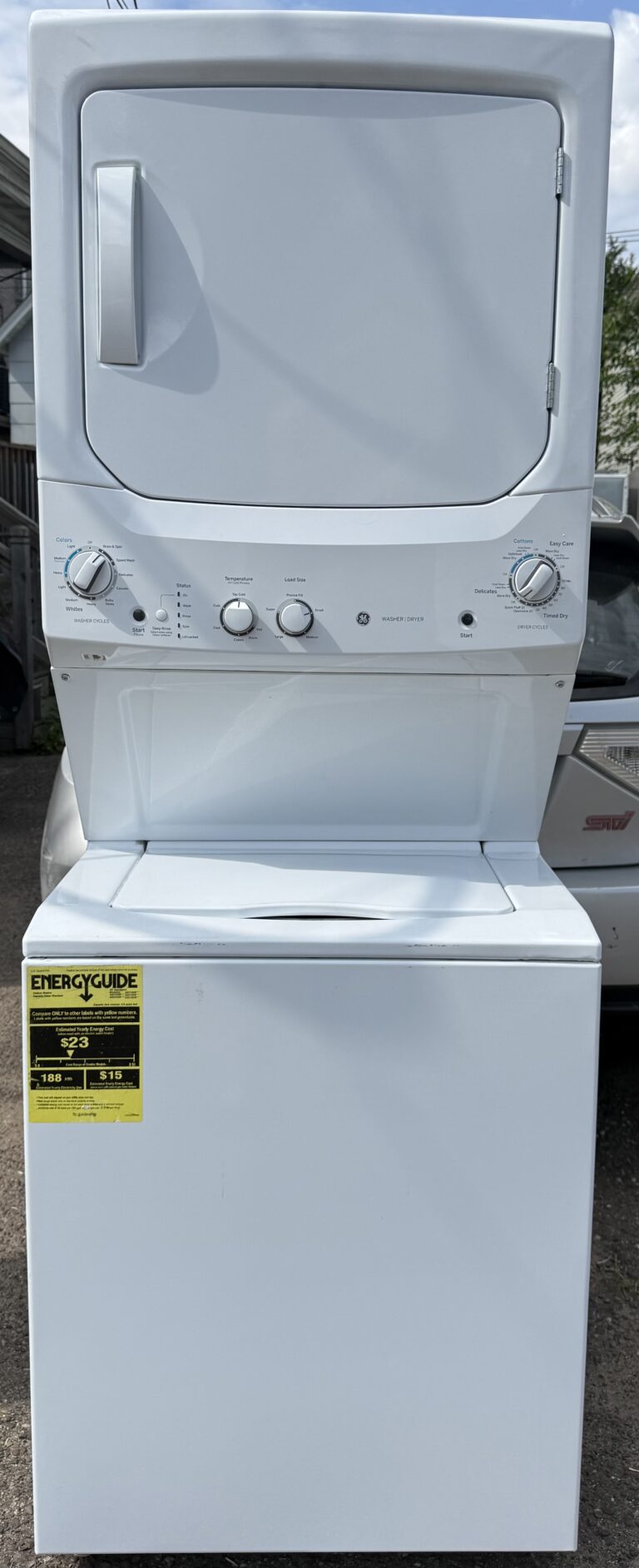 GE white washer and electric dryer laundry center — front view