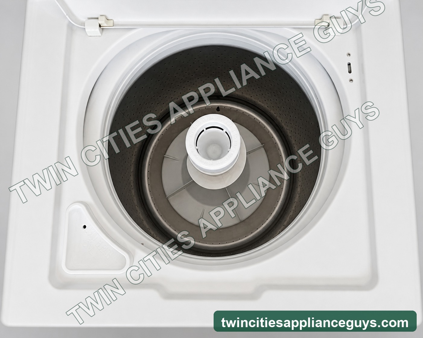 Open stainless wash tub and agitator of Amana top-load washer