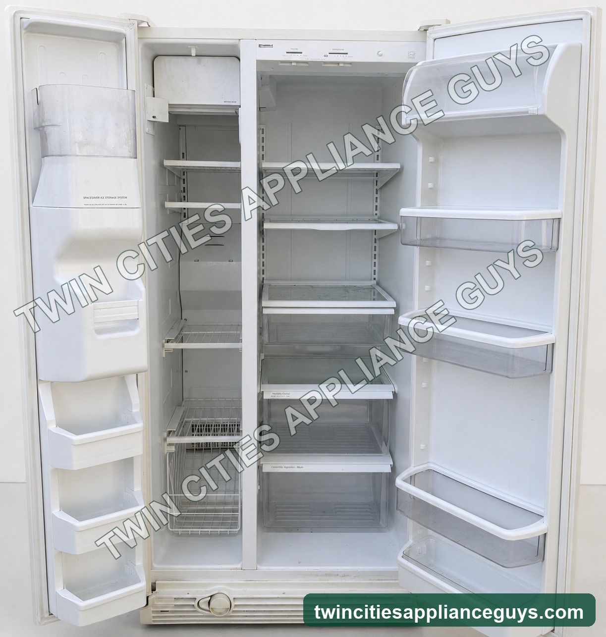 Open Kenmore refrigerator showing freezer and fresh-food compartments