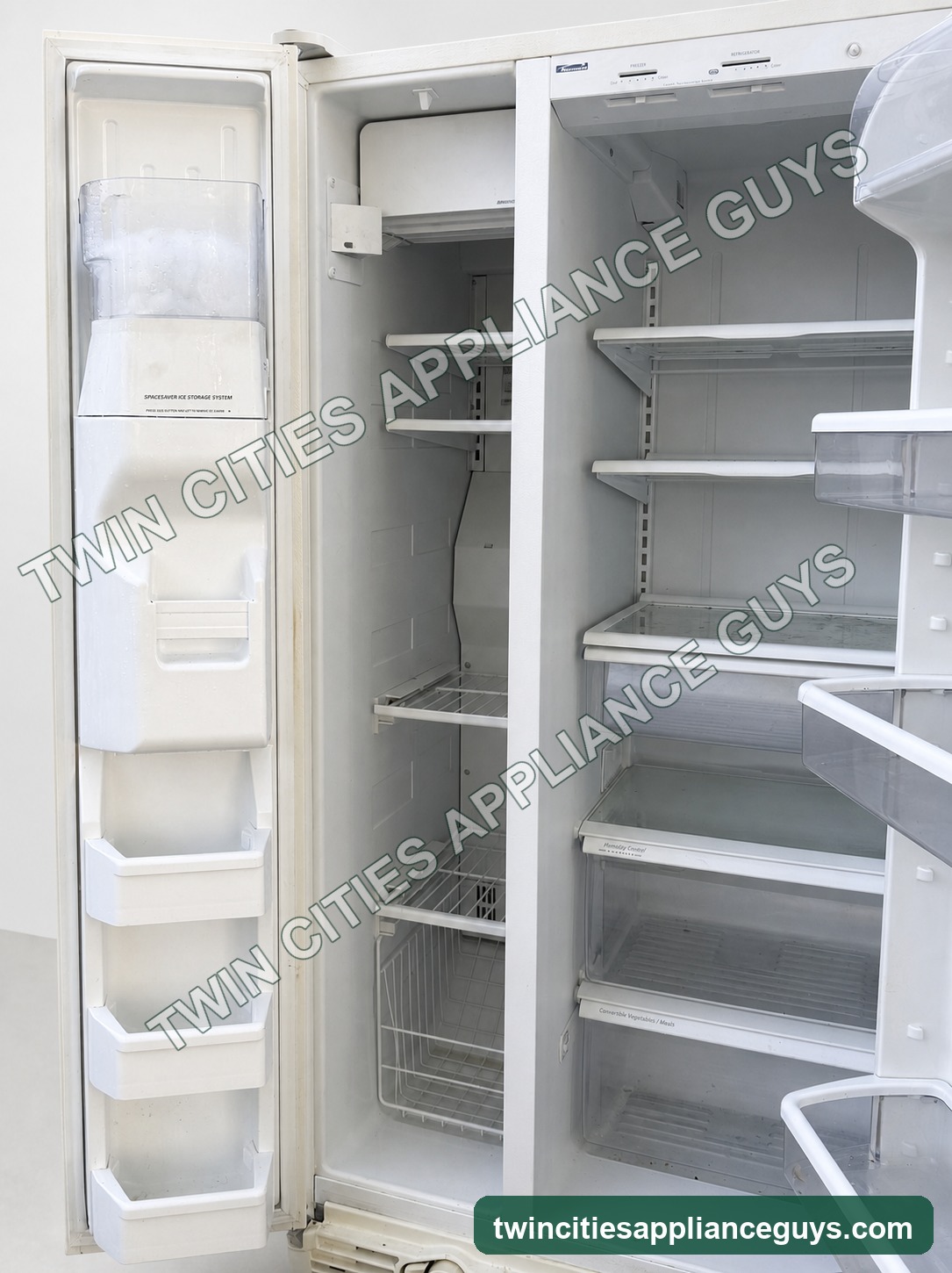 Angled view of open refrigerator shelves and door storage