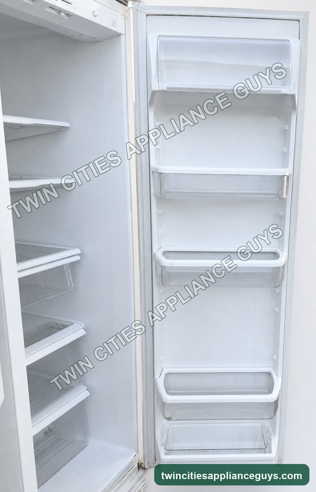 Open refrigerator door showing interior shelves and storage bins