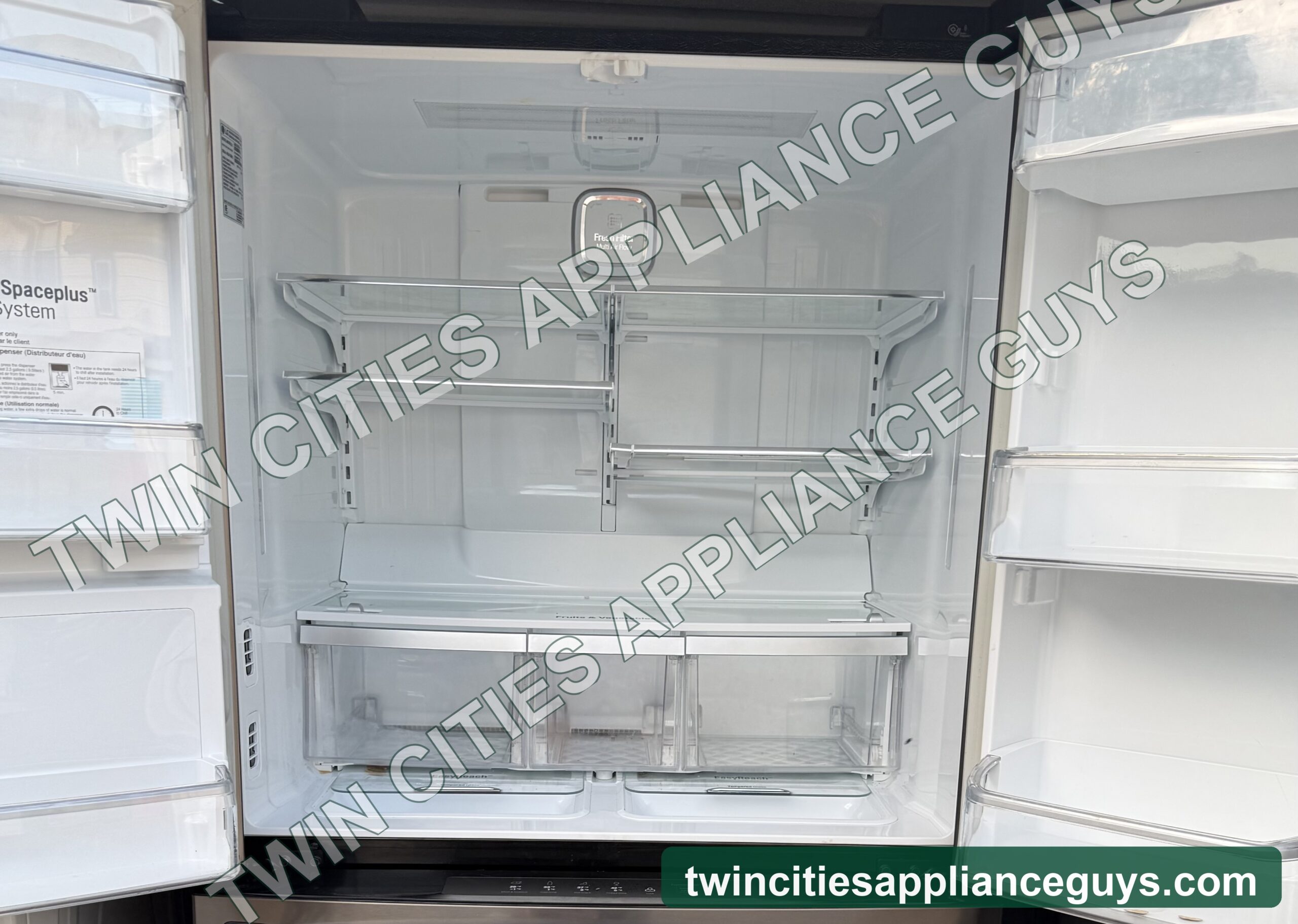 Refrigerator interior with glass shelves and door bins, doors open