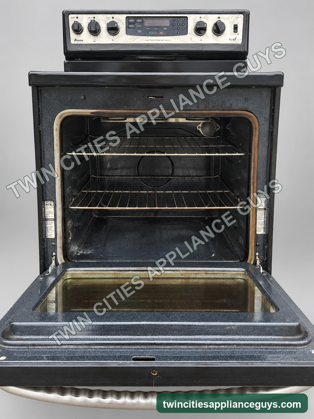 Amana electric range with oven door open showing racks