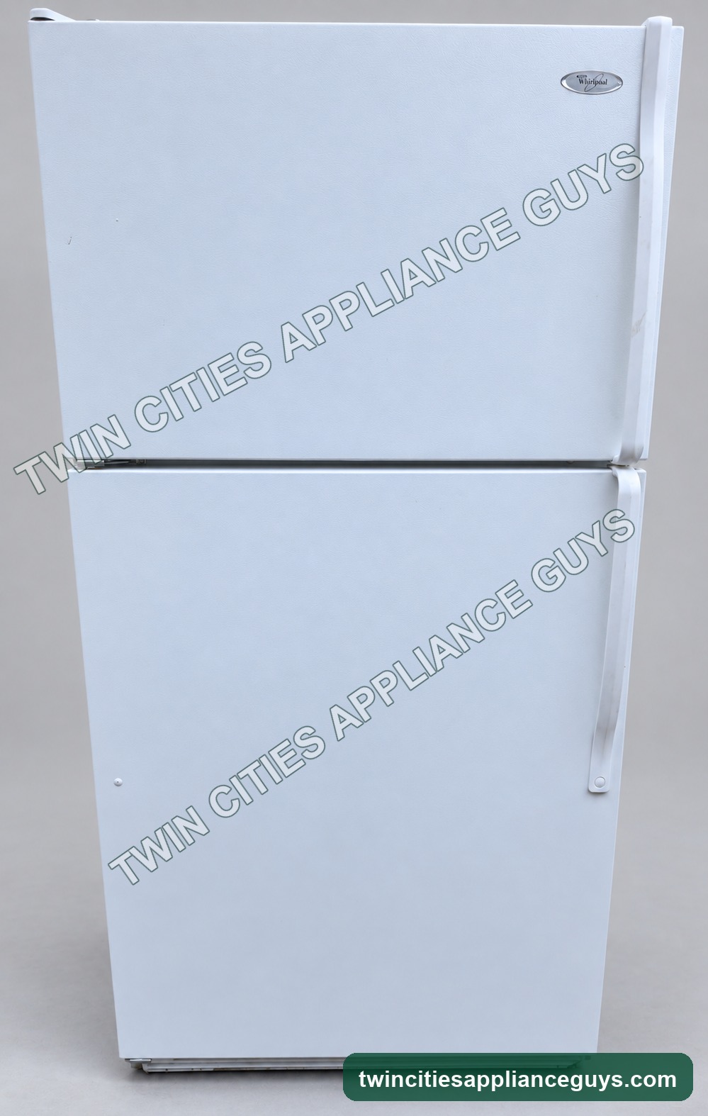Front view of white Whirlpool top-freezer refrigerator