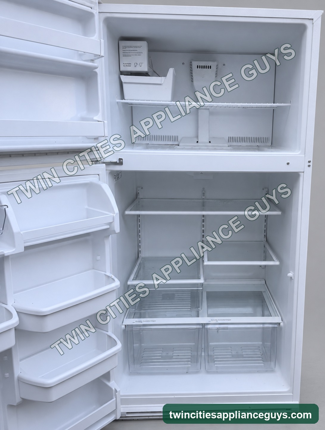 Open interior view of white Whirlpool top-freezer refrigerator