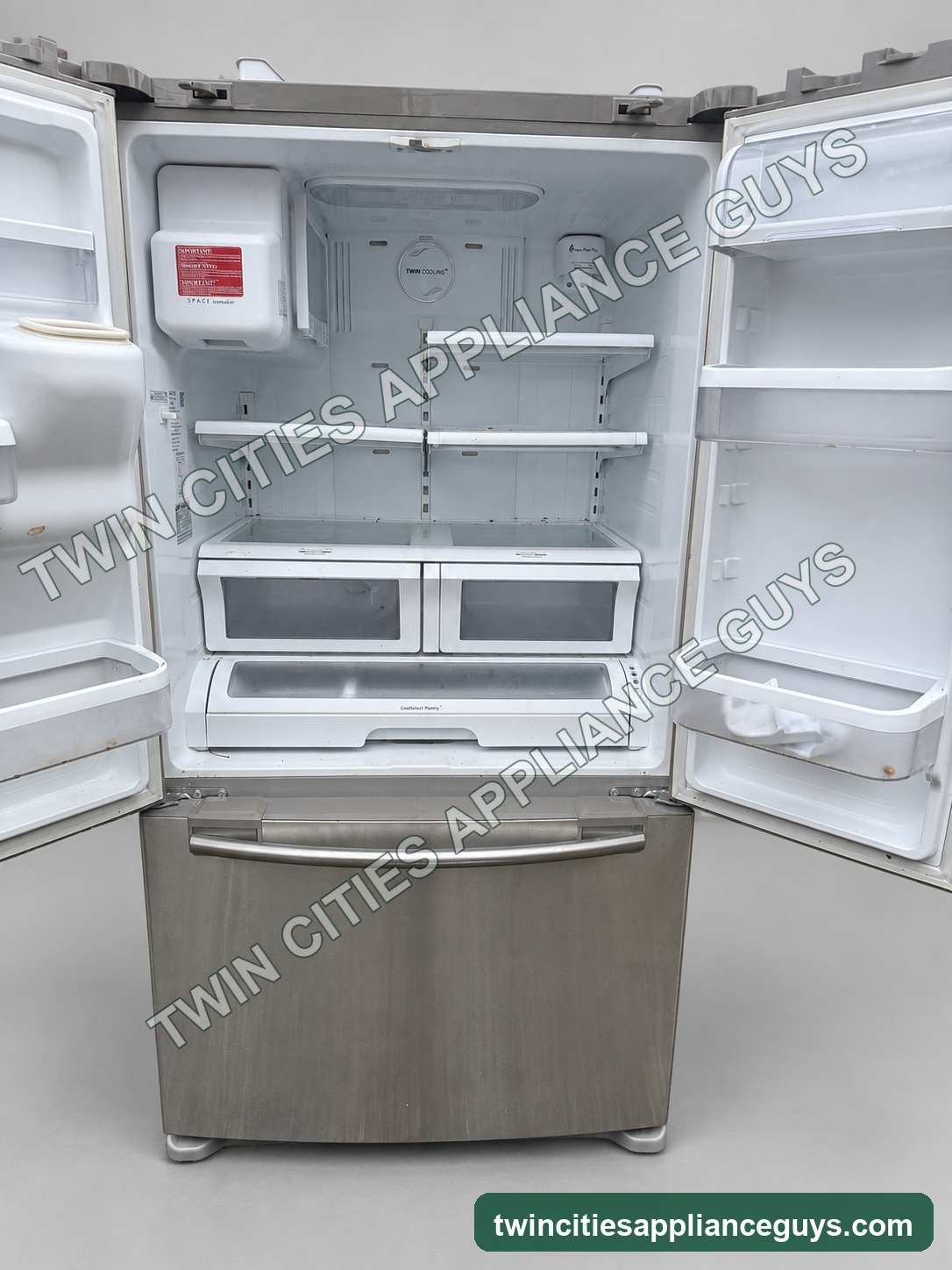 Samsung French-door refrigerator open interior with shelves and drawers