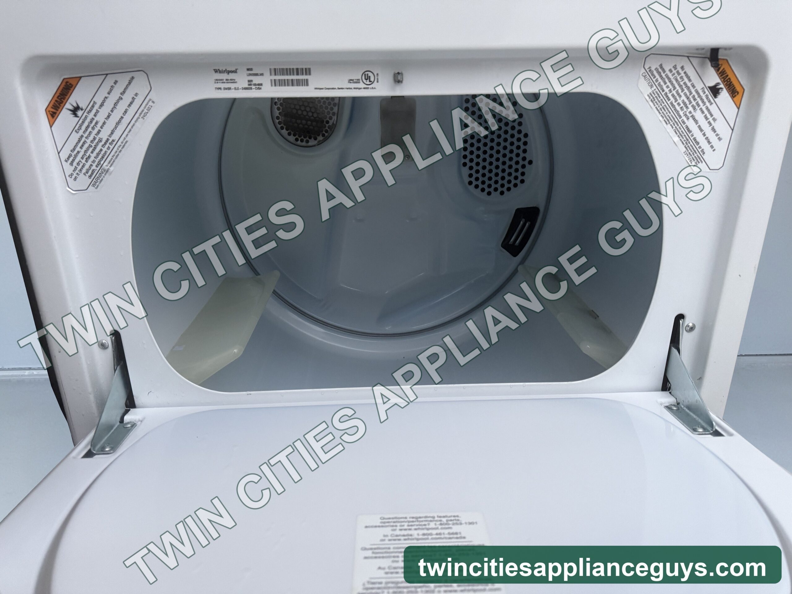 Whirlpool electric dryer with hamper door open showing drum