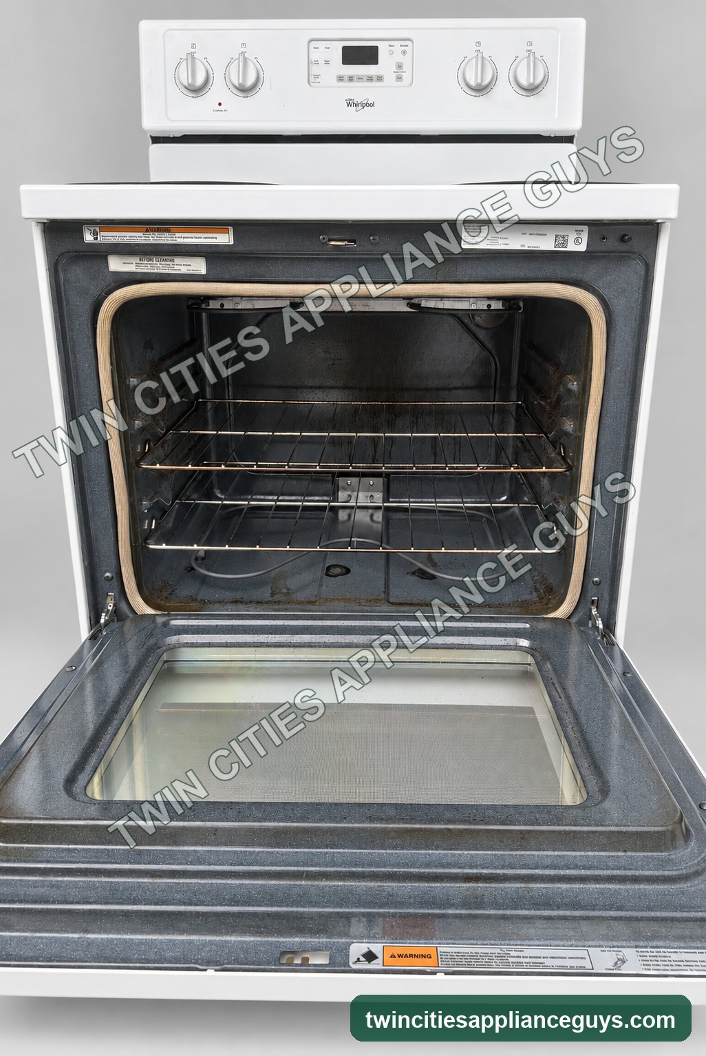 Open oven interior of the white Whirlpool electric coil range