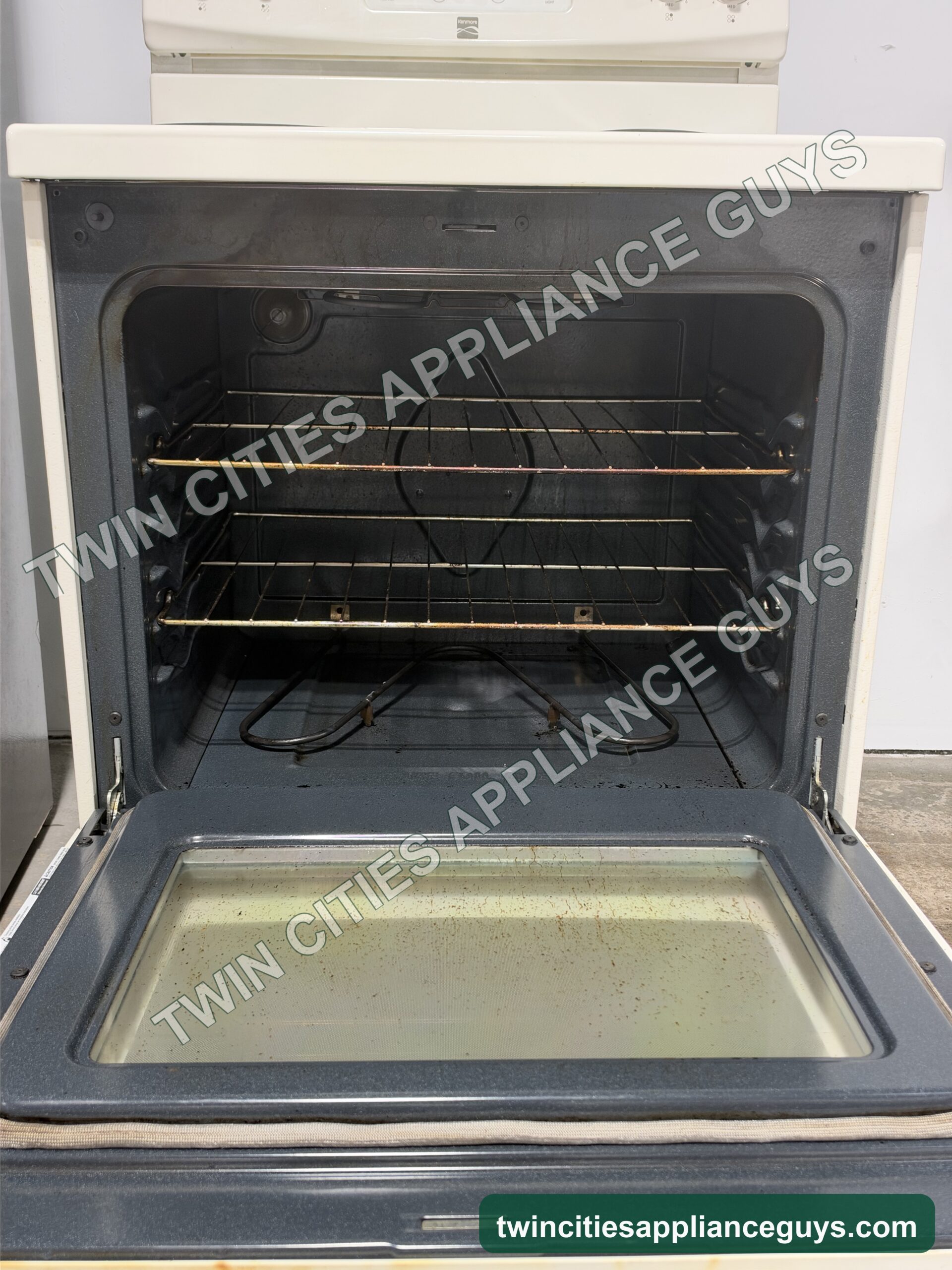 Kenmore electric range with the oven door open showing the oven racks