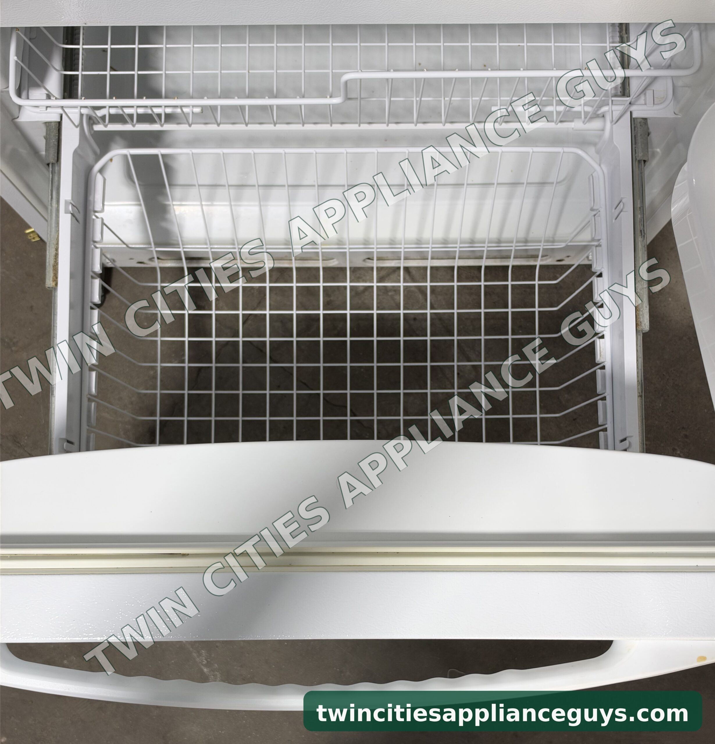 Amana bottom freezer drawer pulled open with wire baskets