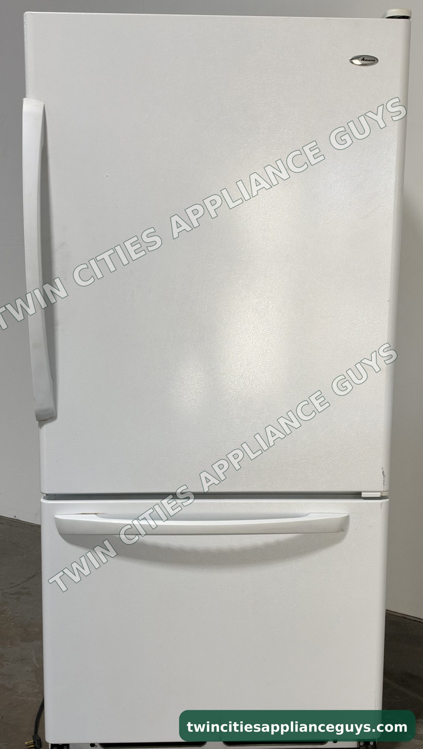 White Amana bottom-freezer refrigerator, front view