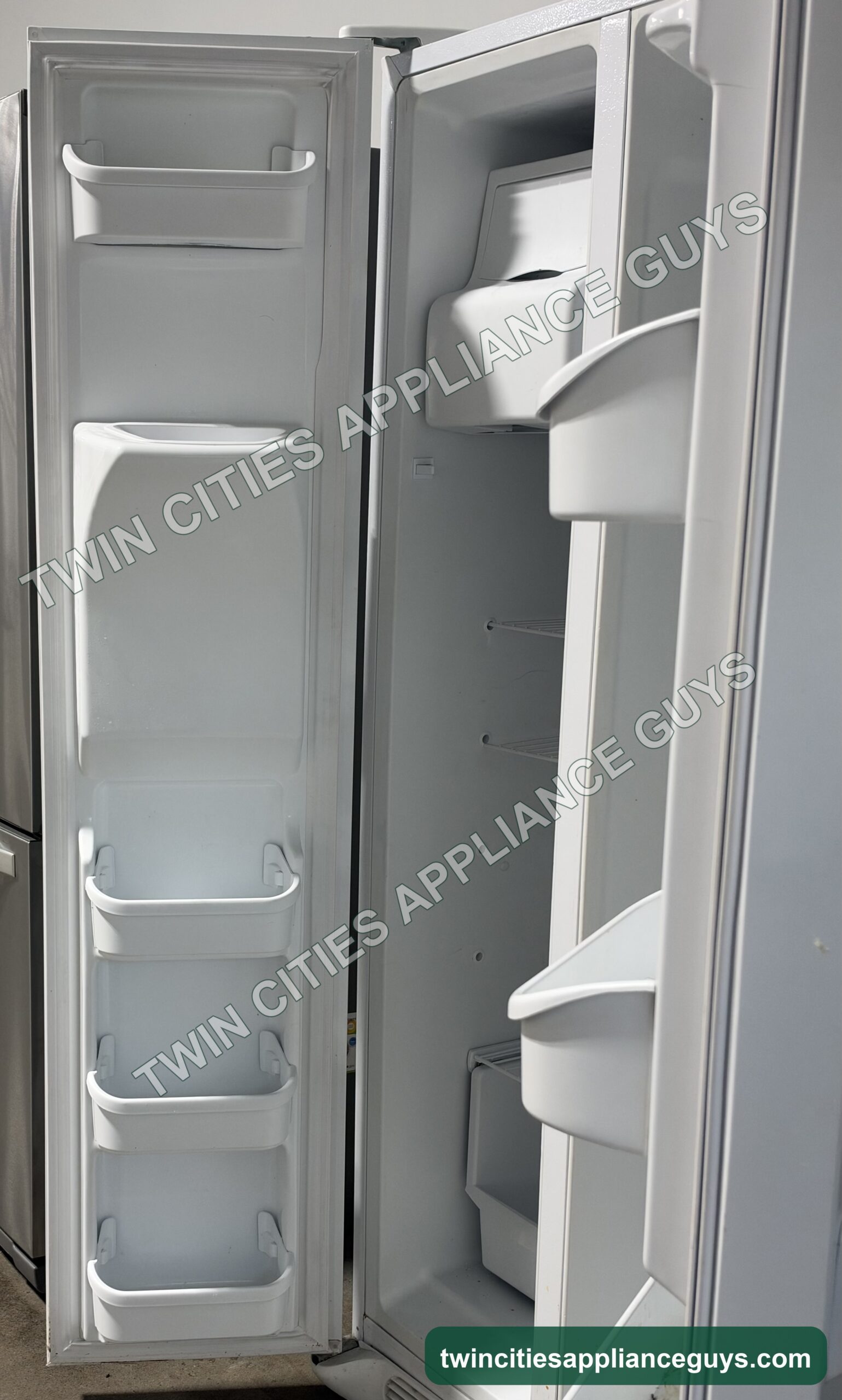 Frigidaire side-by-side refrigerator freezer side showing the ice maker and door bins