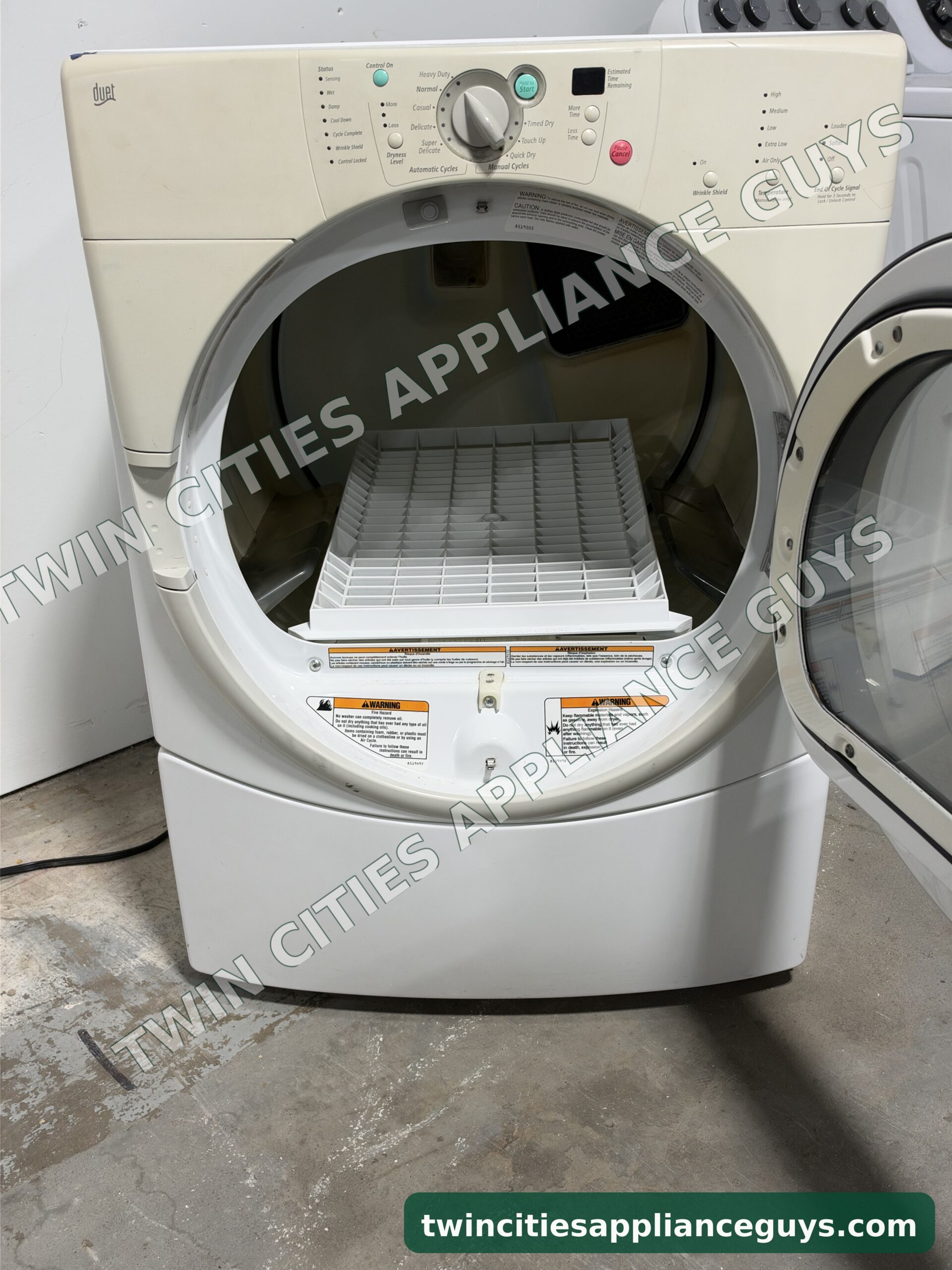 Whirlpool Duet gas dryer with the door open showing the drum and a drying rack