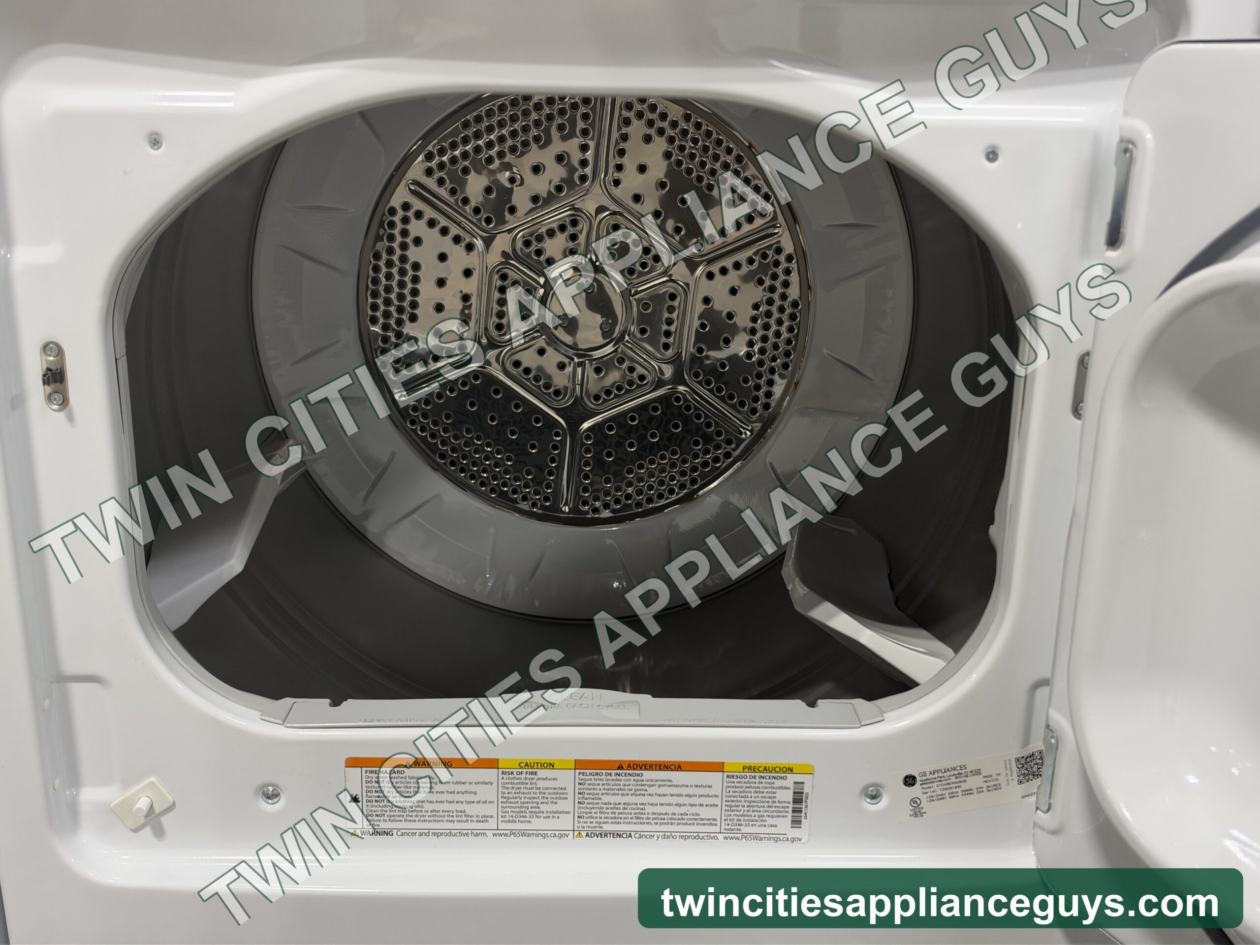 GE electric dryer with the door open showing the drum