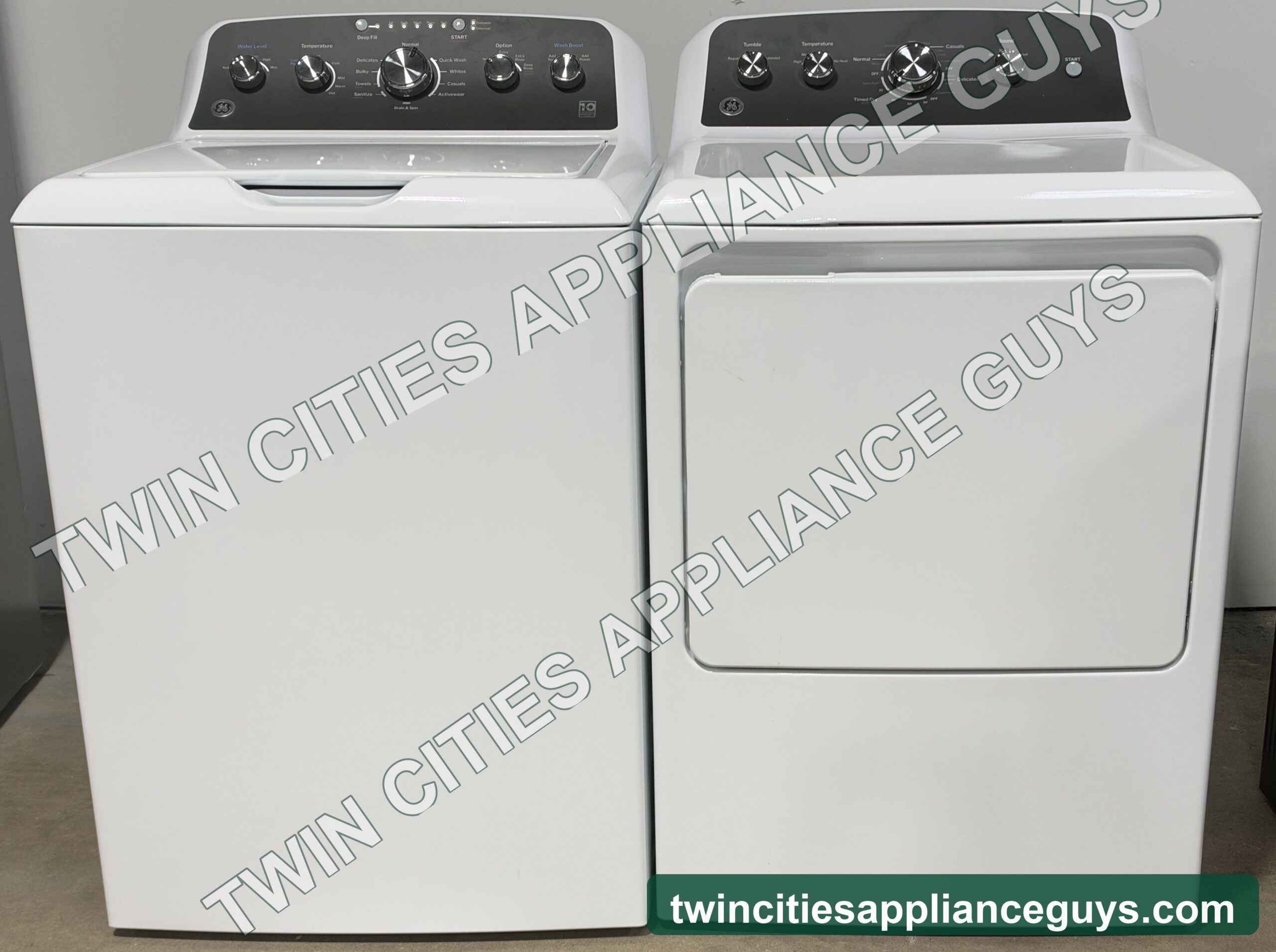 White GE top-load washer and electric dryer side by side, front view