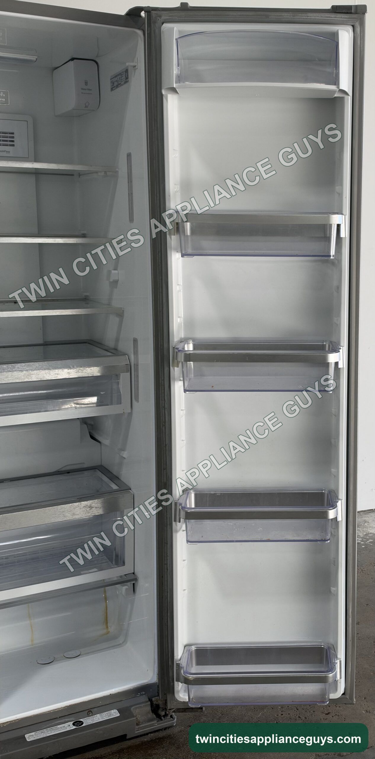 KitchenAid side-by-side refrigerator with doors open showing interior shelves and door bins