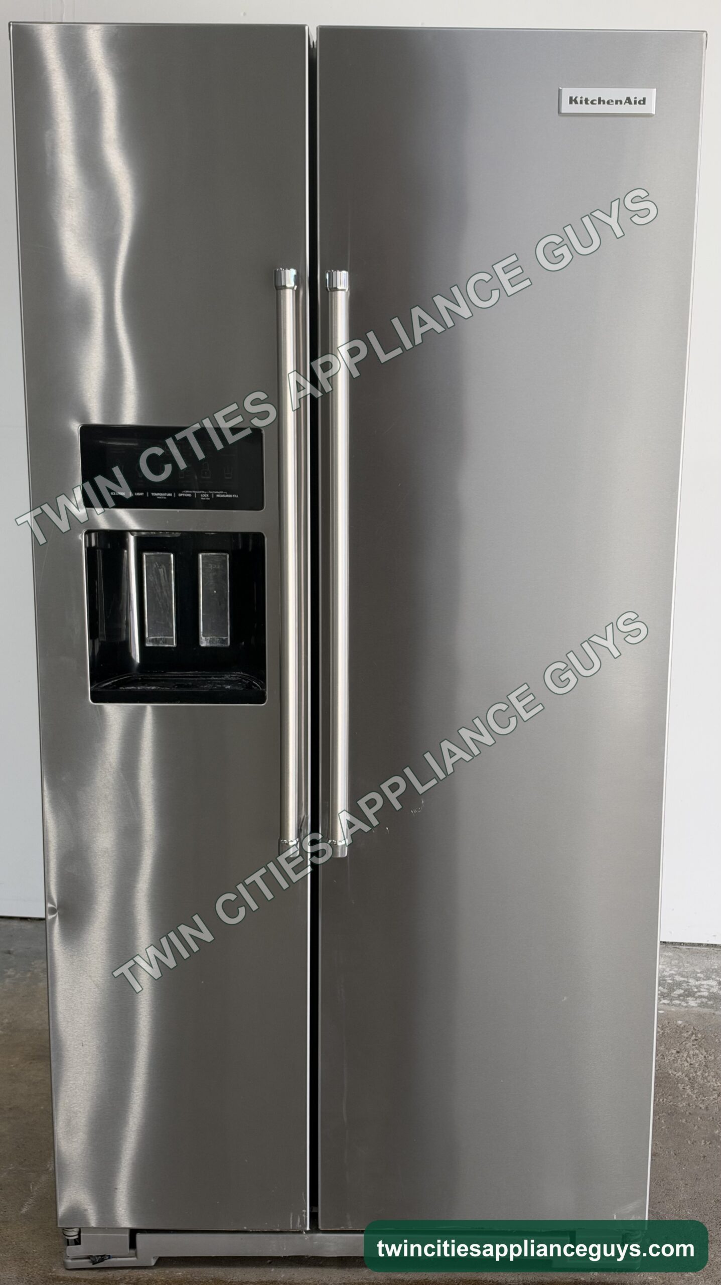 Stainless KitchenAid side-by-side refrigerator front view with doors closed and ice and water dispenser