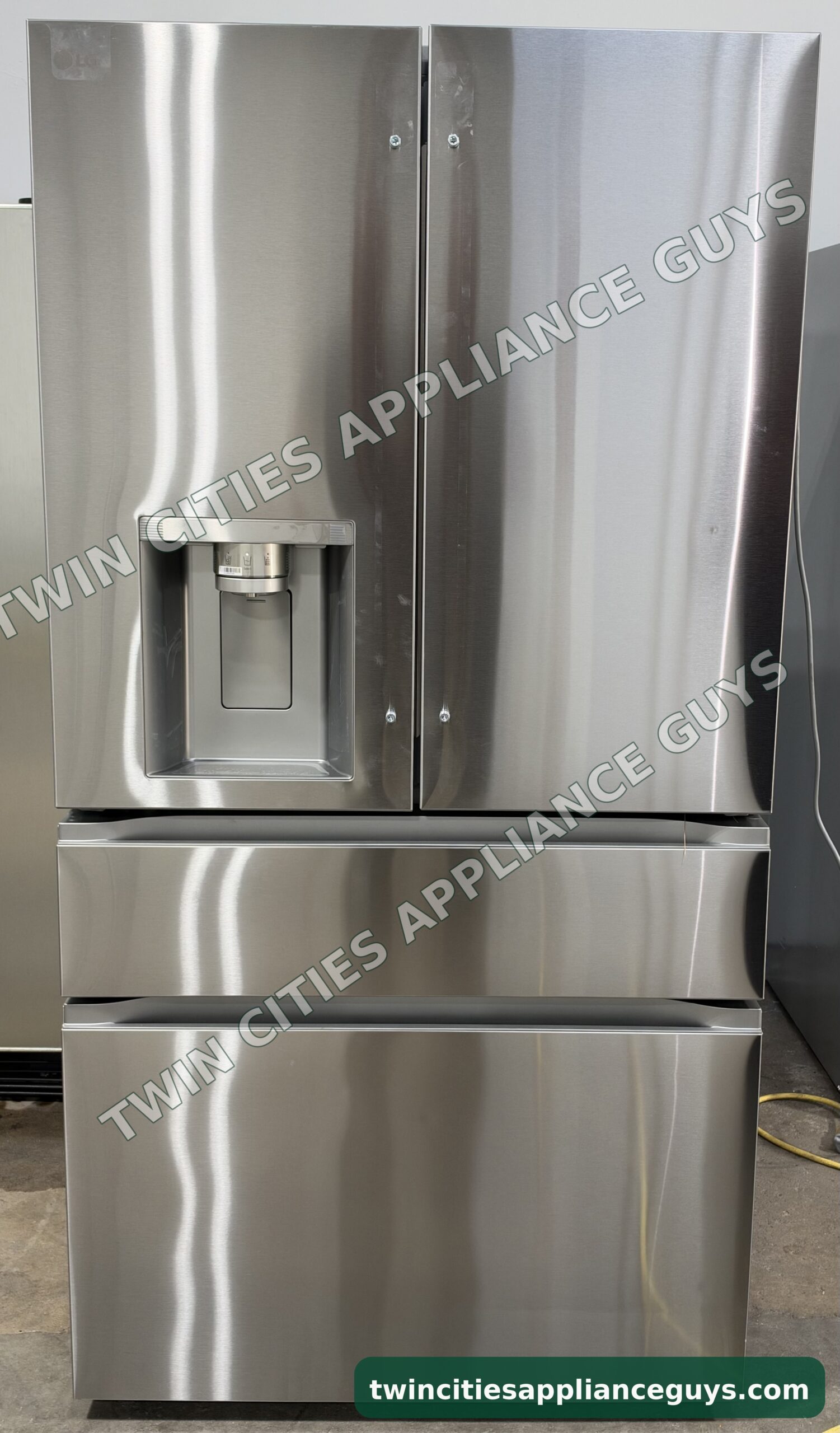 Stainless LG 4-door French door refrigerator front view with the ice and water dispenser