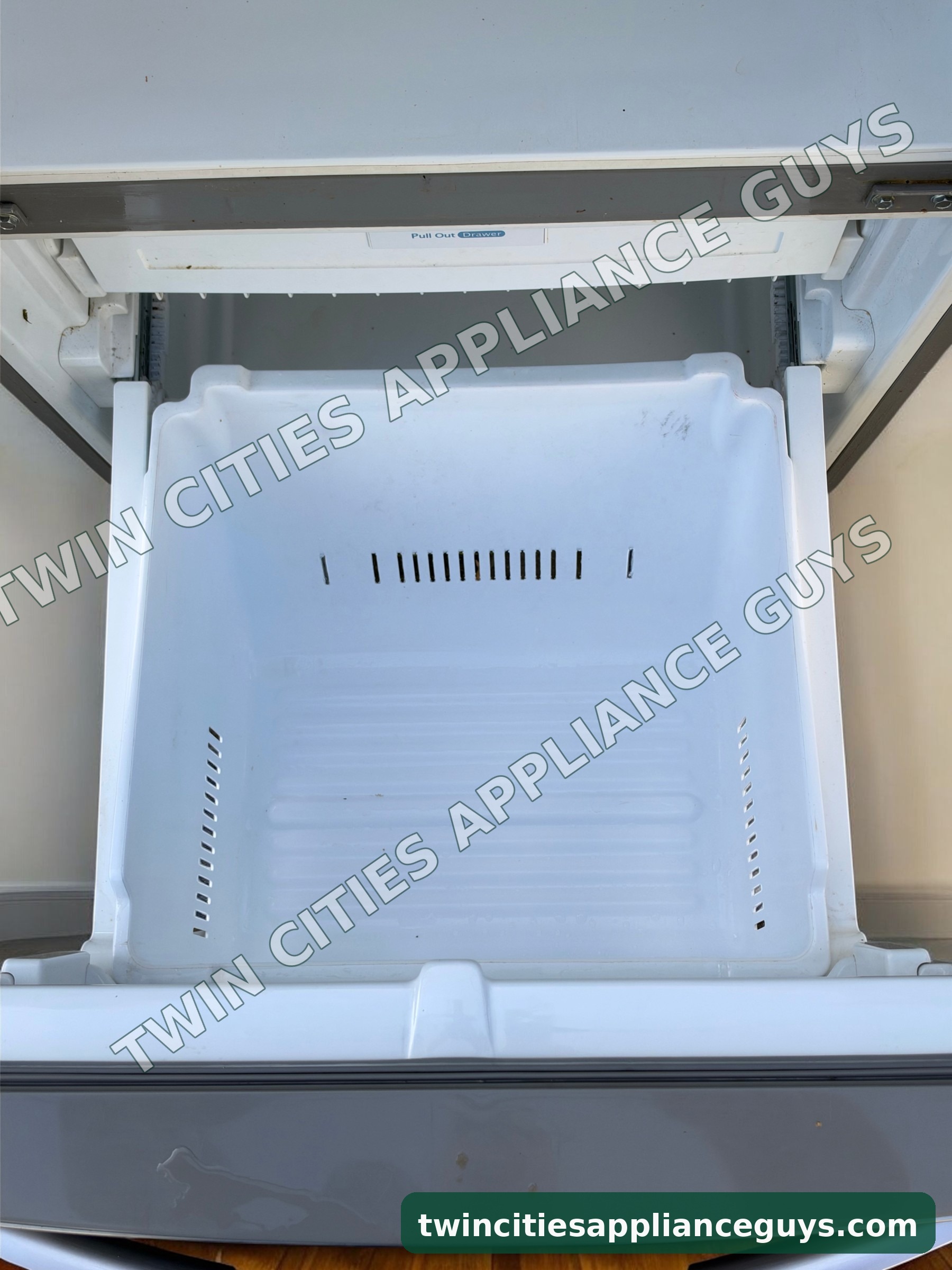 LG refrigerator bottom freezer drawer pulled open showing the freezer basket