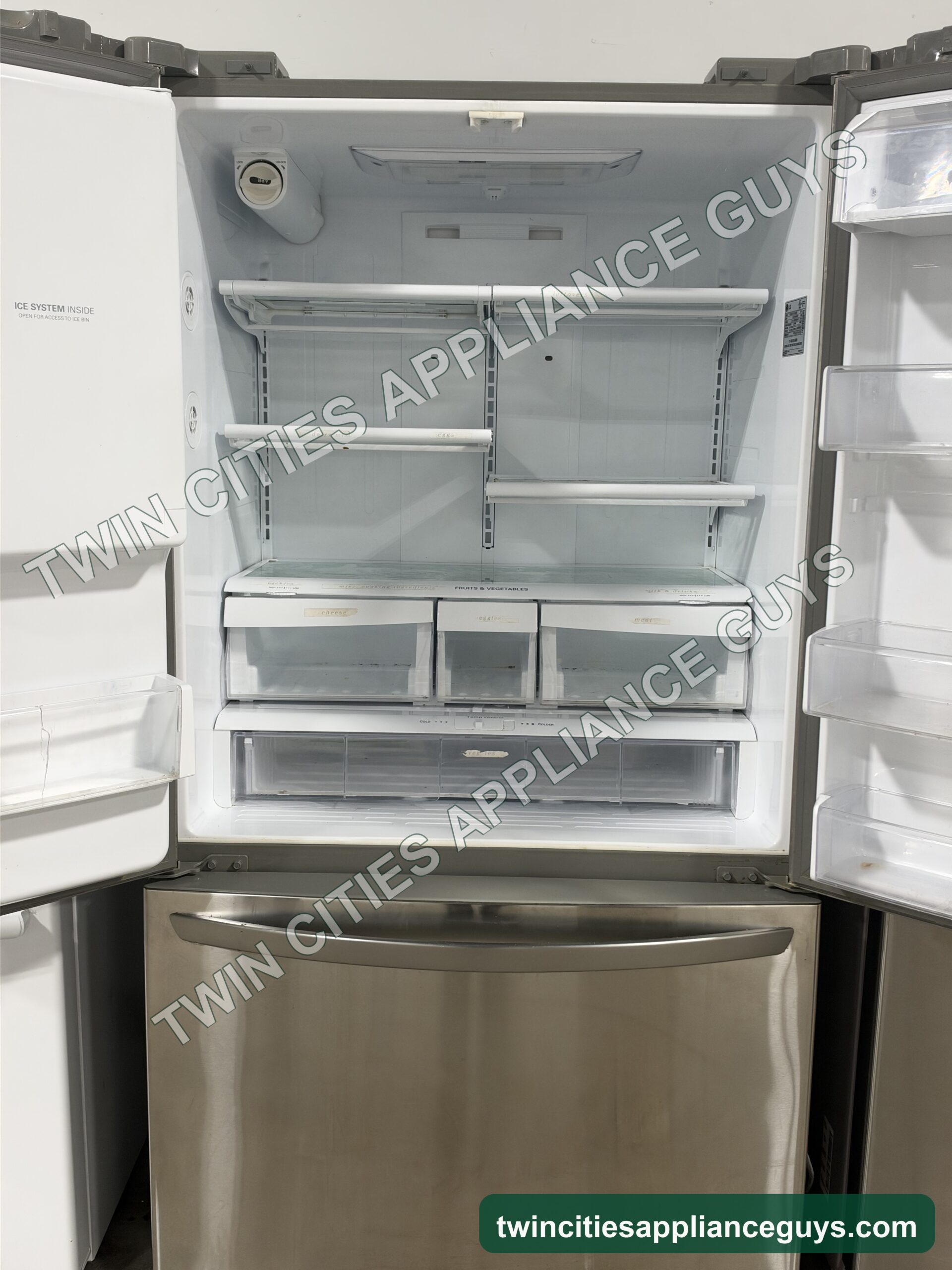 LG French door refrigerator with both doors open showing shelves, crisper drawers and door bins