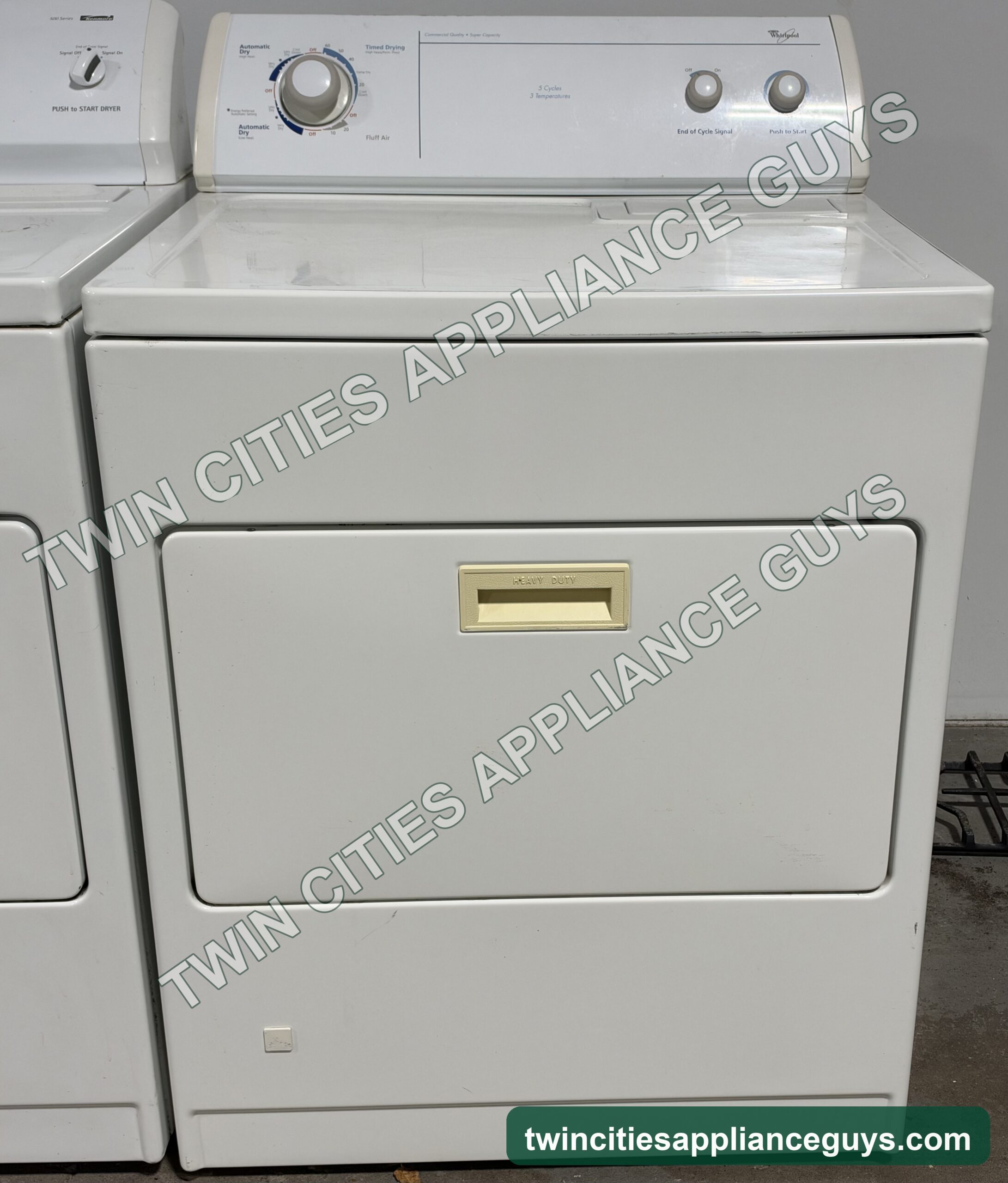 White Whirlpool gas dryer front view with the door closed and control panel