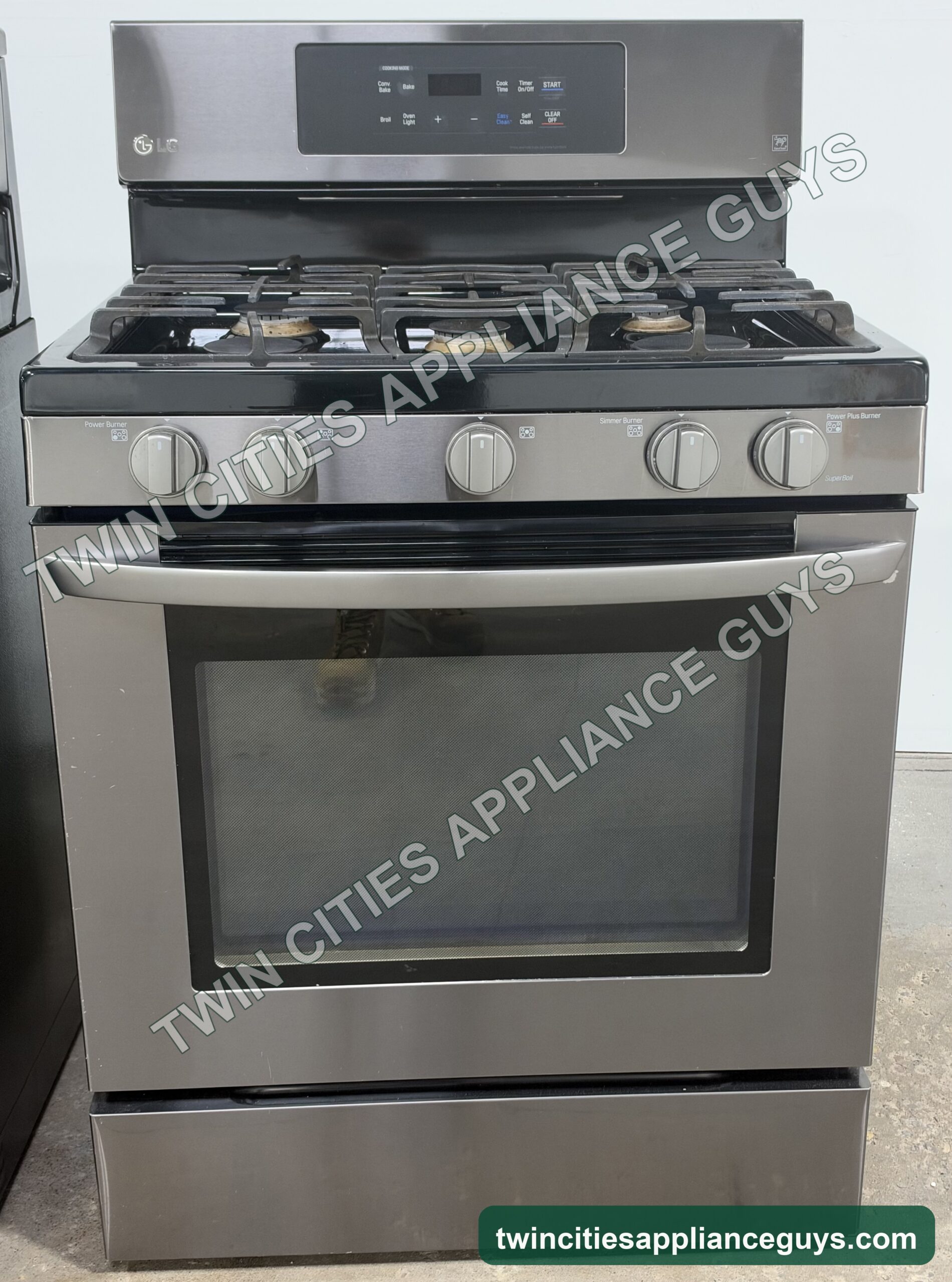 Black stainless LG gas range front view with burner grates and oven door closed