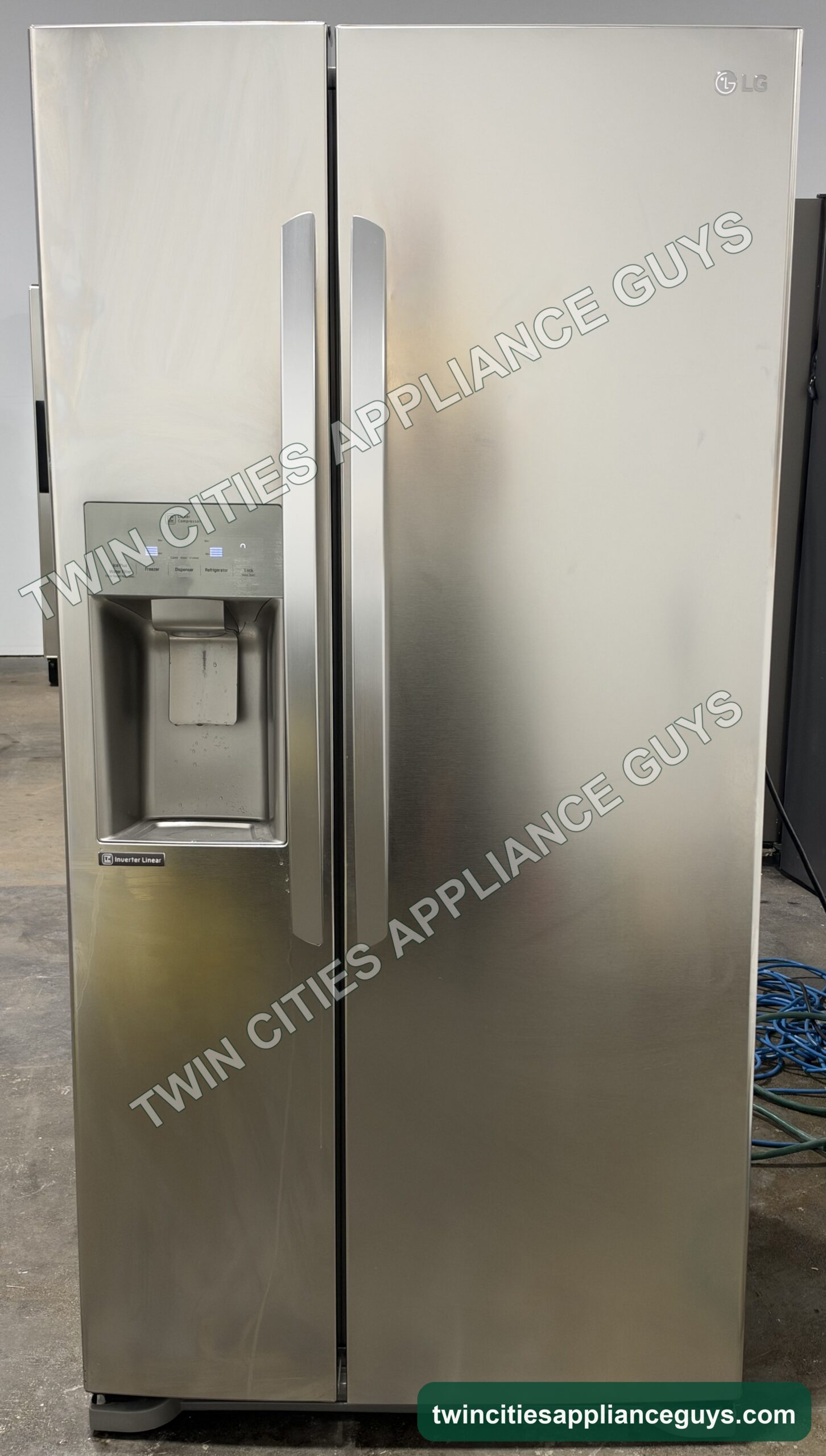 Stainless LG side-by-side refrigerator, front view with external ice and water dispenser