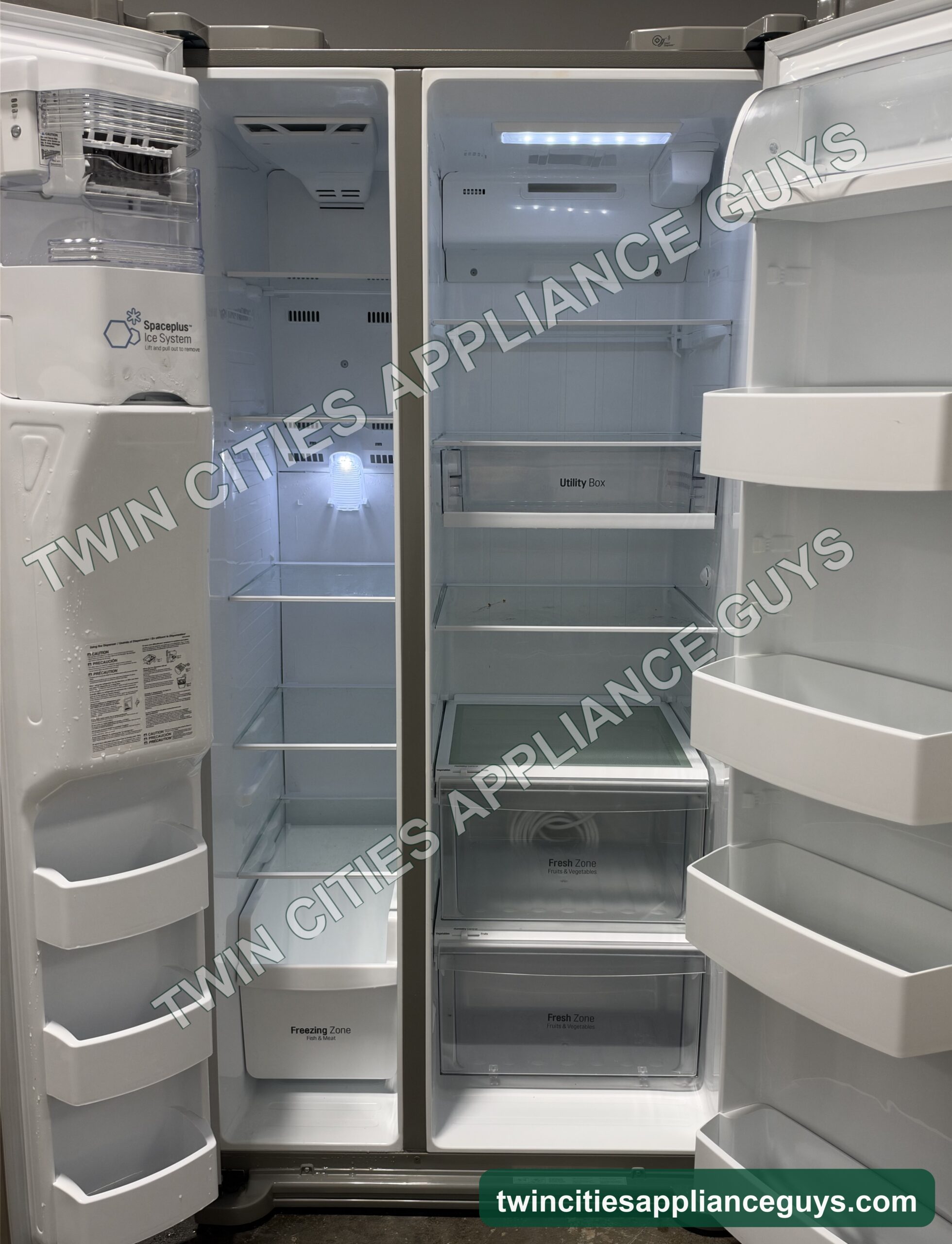 LG side-by-side refrigerator with both doors open showing shelves, drawers and door bins