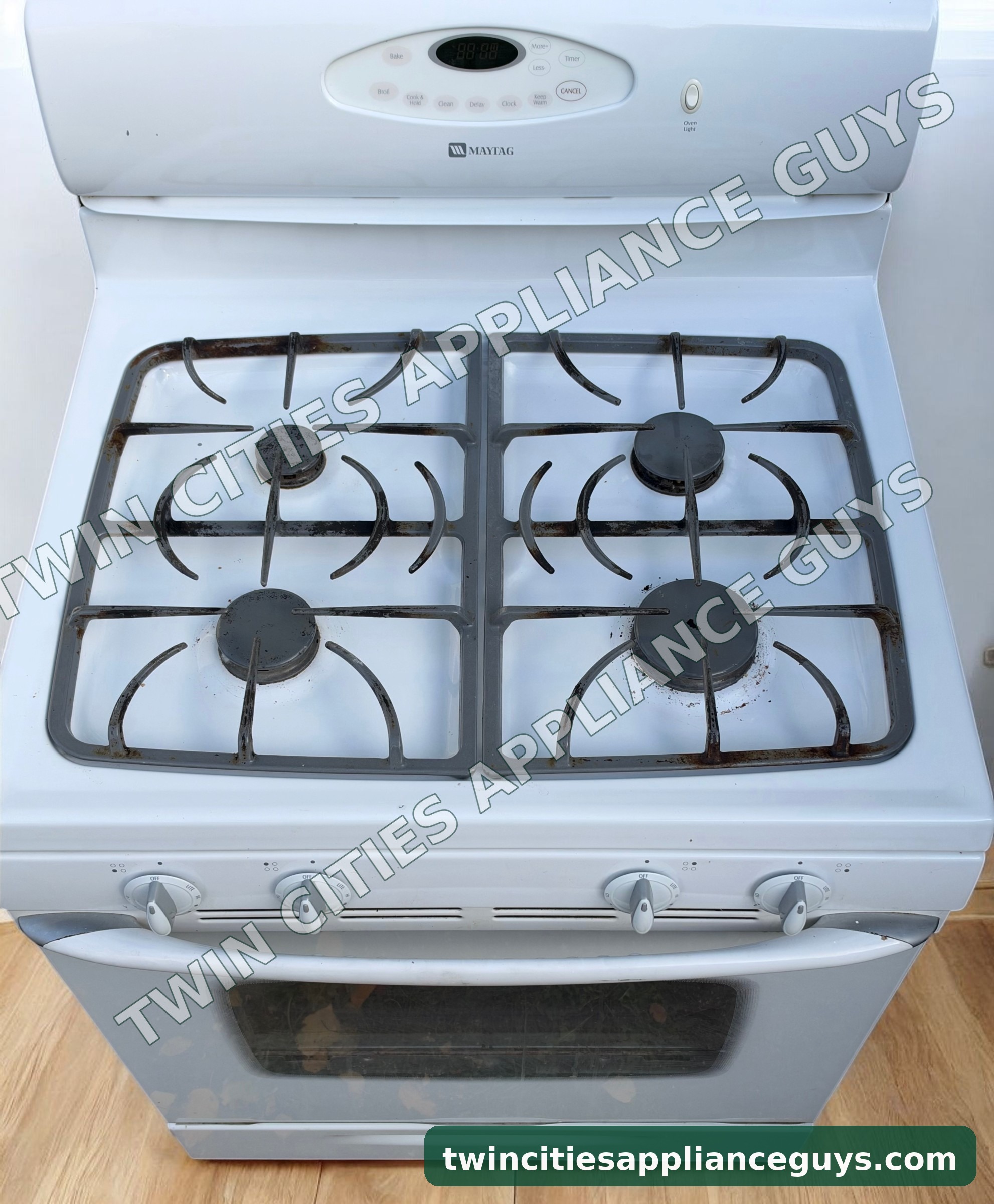 Maytag gas range cooktop seen from above showing four sealed burners and grates