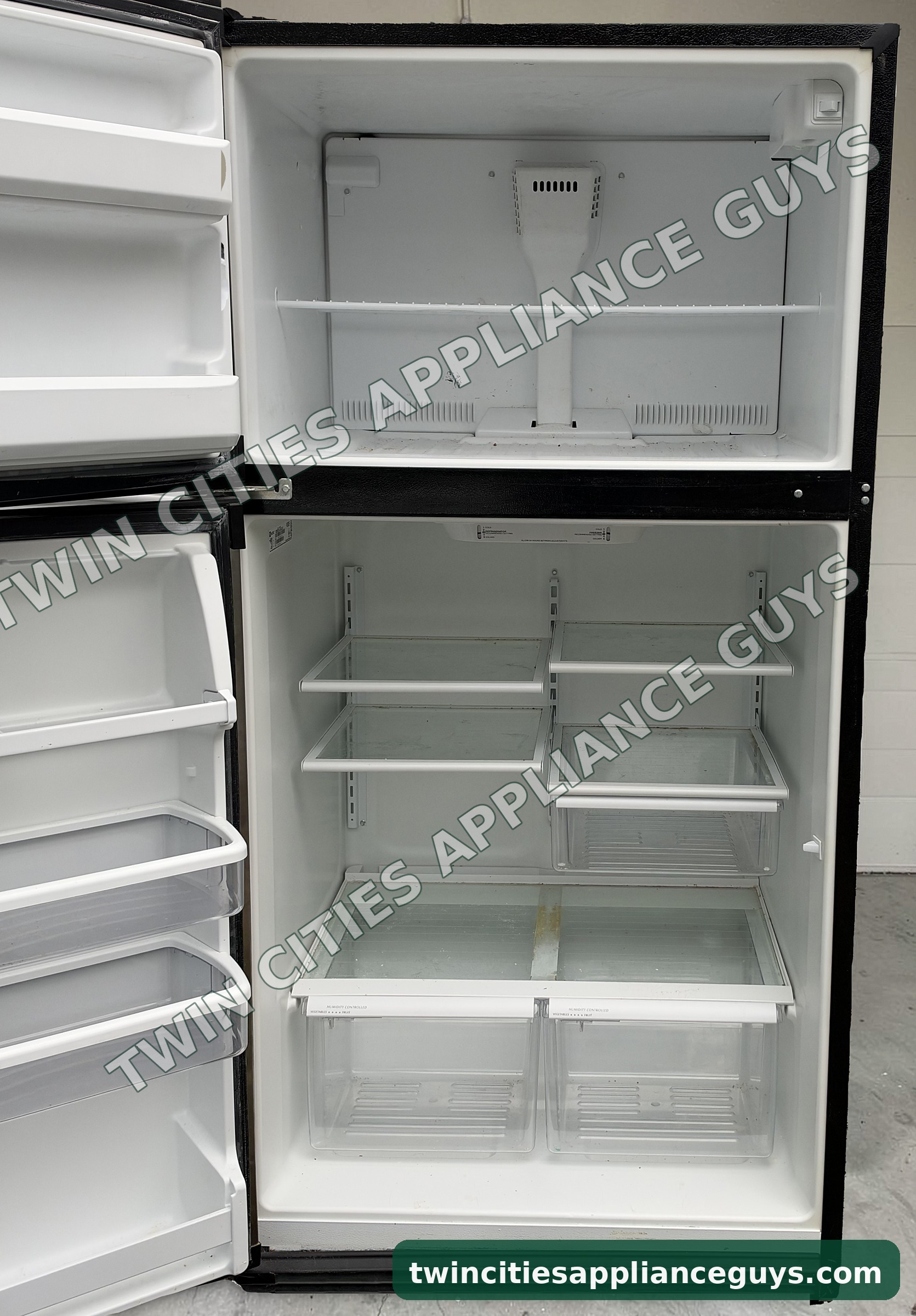 Maytag top-freezer refrigerator with both doors open showing shelves, crispers and door bins