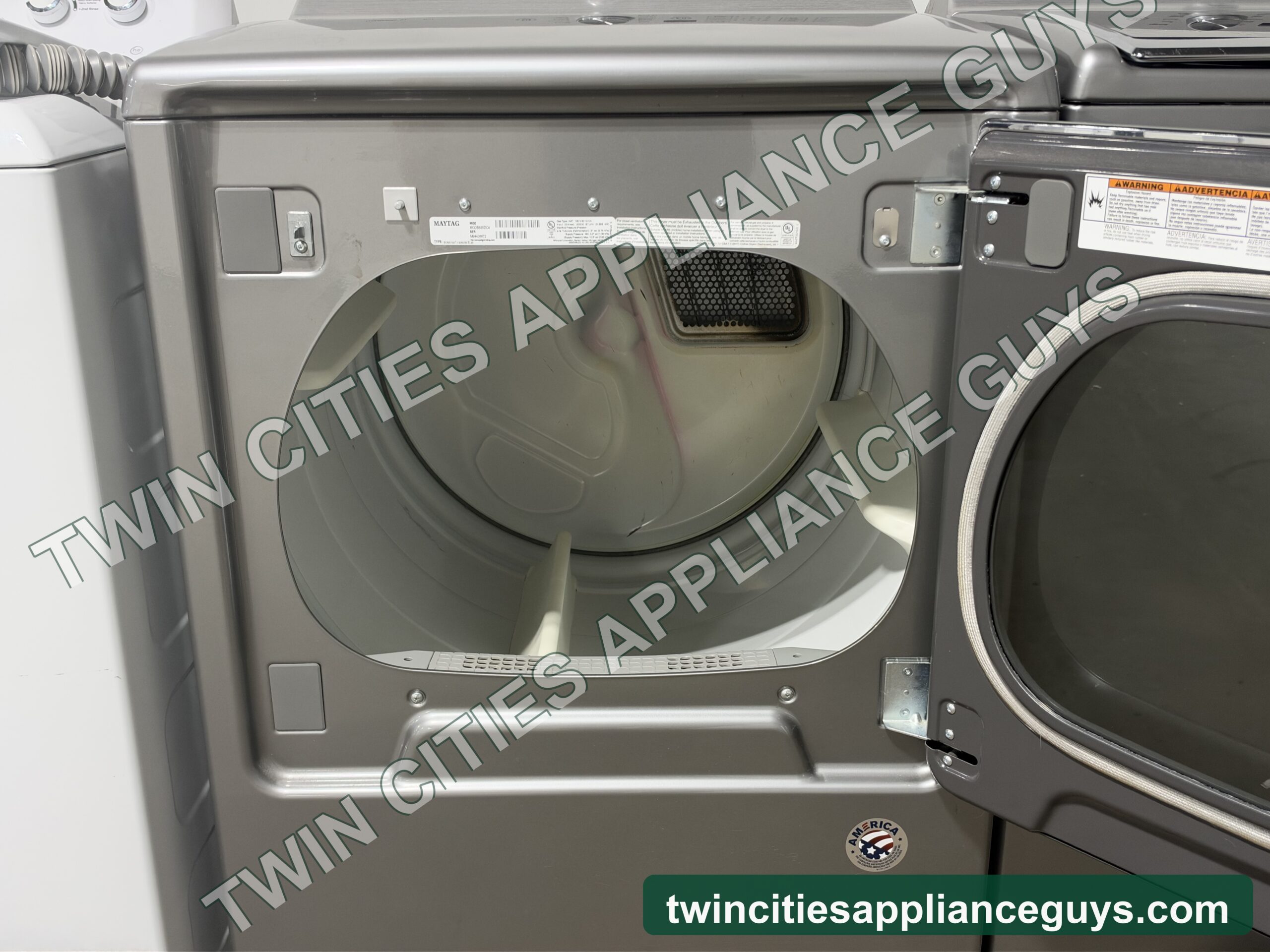 Maytag gas dryer with the door open showing the drum and lint screen